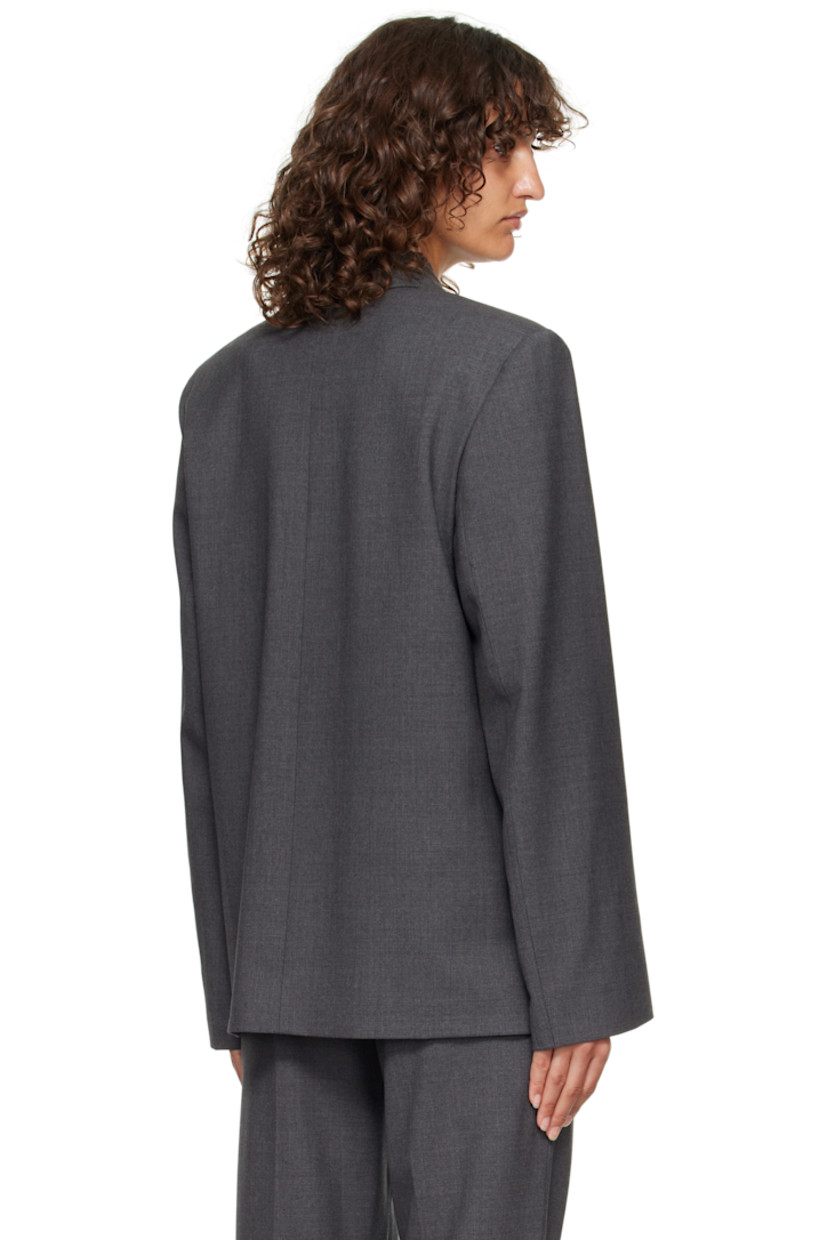 Stretch virgin wool grain de poudre blazer.

· OEKO-TEX® STANDARD 100-certified
· Shawl lapel
· Double-breasted button closure
· Welt pockets at waist
· Padded shoulders
· Welt pocket at interior
· Full satin lining

Supplier color: Anthracite melange