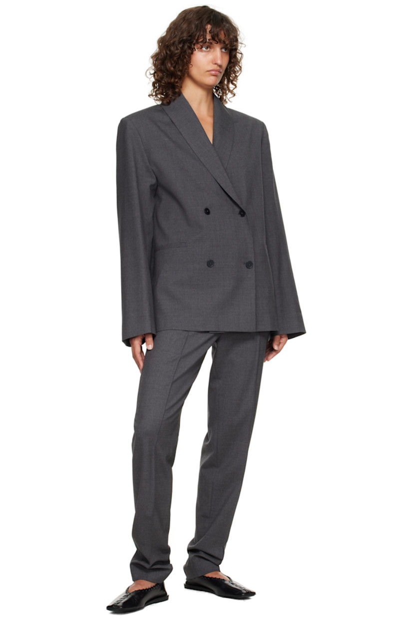 Stretch virgin wool grain de poudre blazer.

· OEKO-TEX® STANDARD 100-certified
· Shawl lapel
· Double-breasted button closure
· Welt pockets at waist
· Padded shoulders
· Welt pocket at interior
· Full satin lining

Supplier color: Anthracite melange