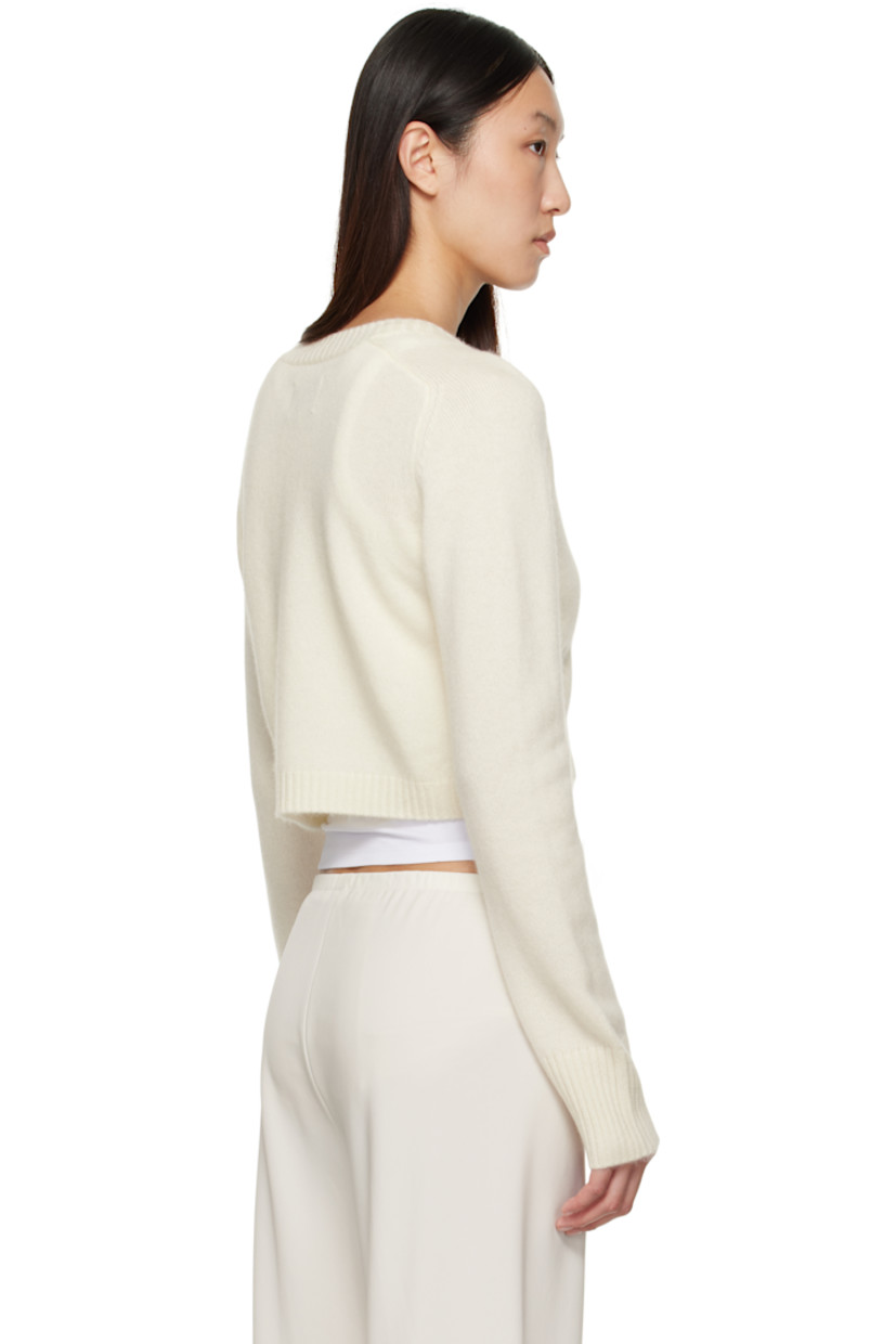 Knit cashmere cardigan.

· OEKO-TEX® STANDARD 100-certified
· Rib-knit crewneck, placket, hem, and cuffs
· Button closure
· Logo embroidered at front hem
· Cropped hem
· Saddle shoulders

Supplier color: Ivory
