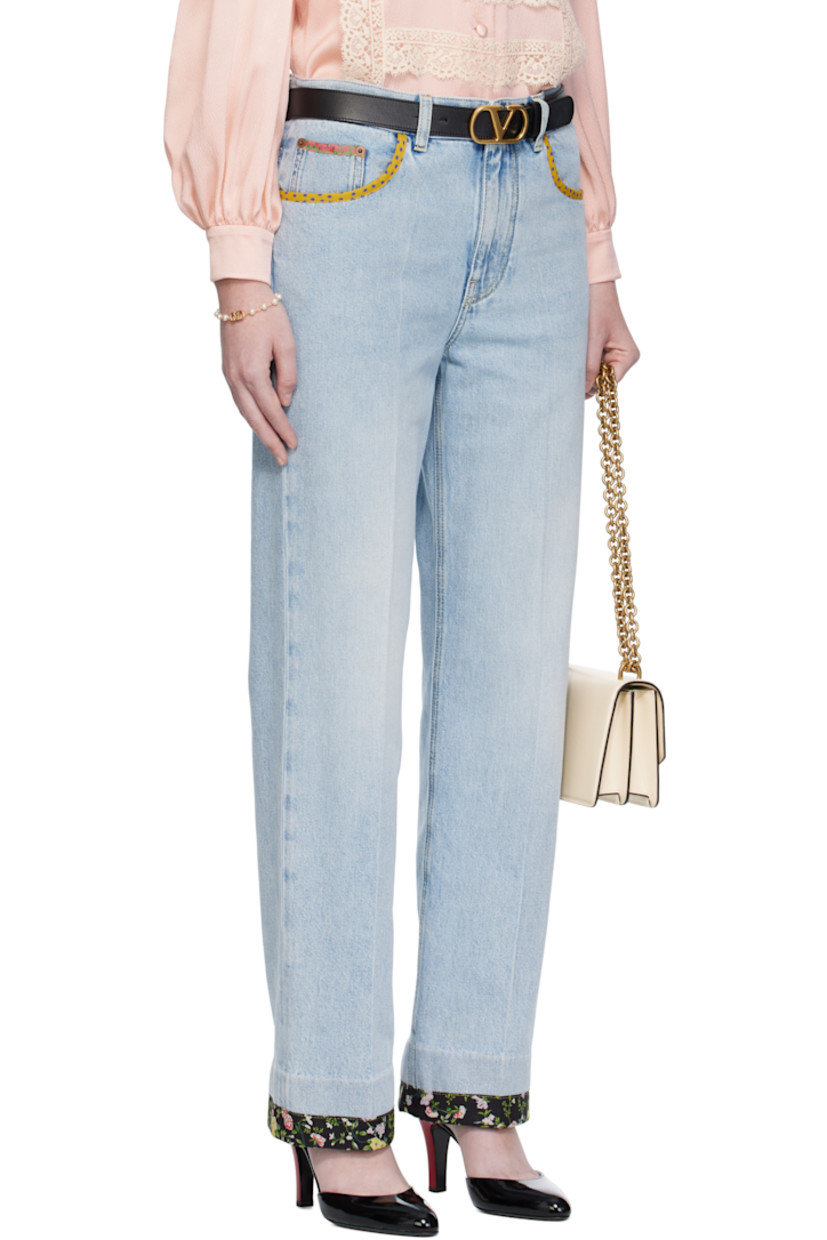 Non-stretch denim jeans.

· Fading and floral-printed trim throughout
· Belt loops
· Five-pocket styling
· Zip fly
· Creased legs
· Leather logo patch at back waistband
· Logo-engraved bronze-tone hardware
· Contrast stitching in yellow

Supplier color: Denim