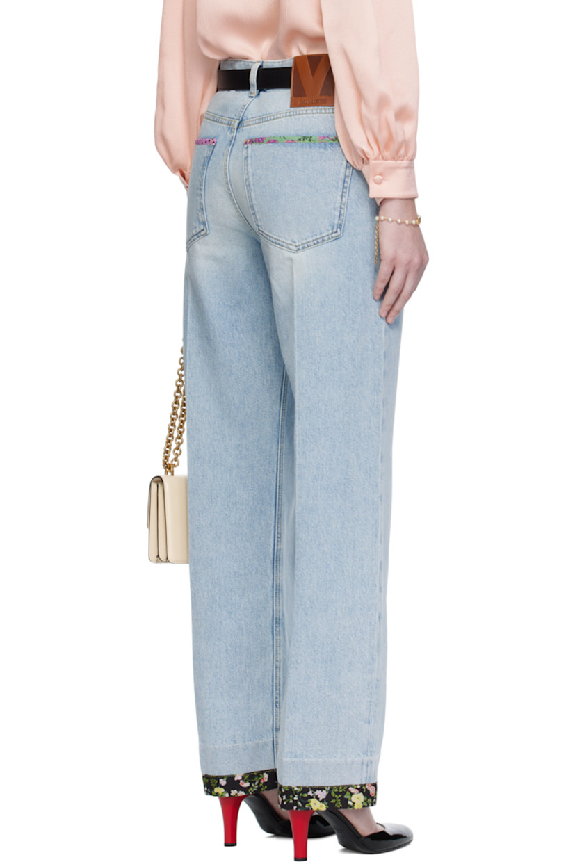 Non-stretch denim jeans.

· Fading and floral-printed trim throughout
· Belt loops
· Five-pocket styling
· Zip fly
· Creased legs
· Leather logo patch at back waistband
· Logo-engraved bronze-tone hardware
· Contrast stitching in yellow

Supplier color: Denim