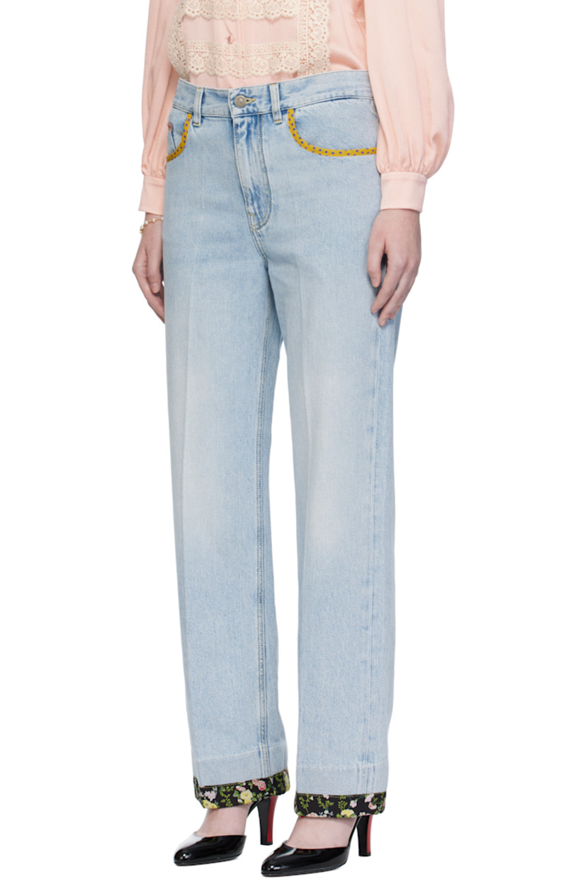 Non-stretch denim jeans.

· Fading and floral-printed trim throughout
· Belt loops
· Five-pocket styling
· Zip fly
· Creased legs
· Leather logo patch at back waistband
· Logo-engraved bronze-tone hardware
· Contrast stitching in yellow

Supplier color: Denim