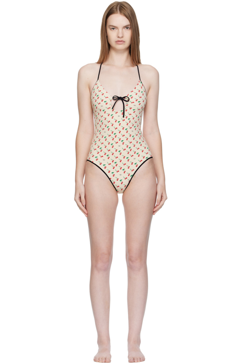 Stretch nylon jersey one-piece swimsuit. 

· Logo and graphic pattern printed throughout
· V-neck
· Self-tie bow accent at chest
· Elasticized halter strap
· Self-tie strap and logo hardware at low back
· Full stretch jersey lining

Supplier color: Birch/Cherry
