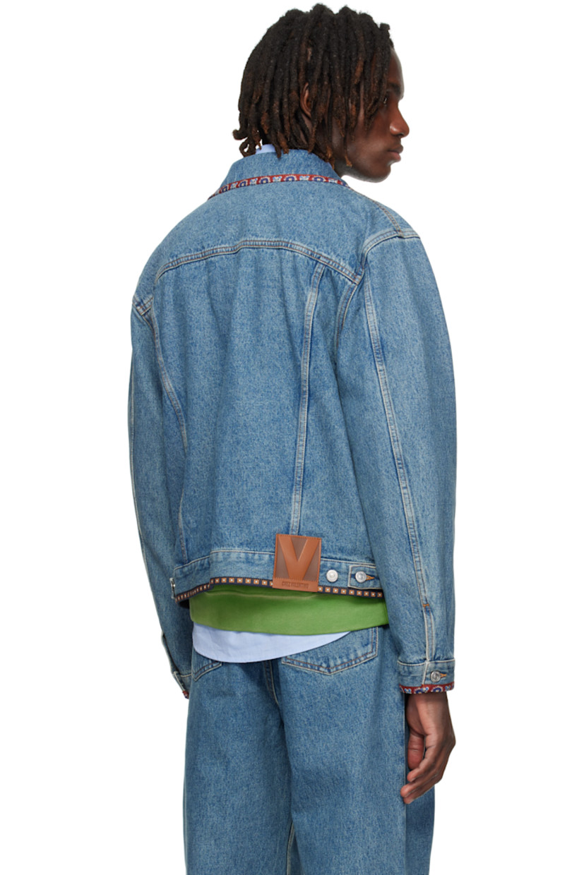 Non-stretch denim jacket.

· Fading and graphic-printed poplin trim throughout
· Beaded appliqués at spread collar and chest
· Button closure
· Flap and welt pockets at front
· Buttoned cuffs
· Logo patch and adjustable button tabs at back hem
· Contrast stitching in tan

Supplier color: Blue