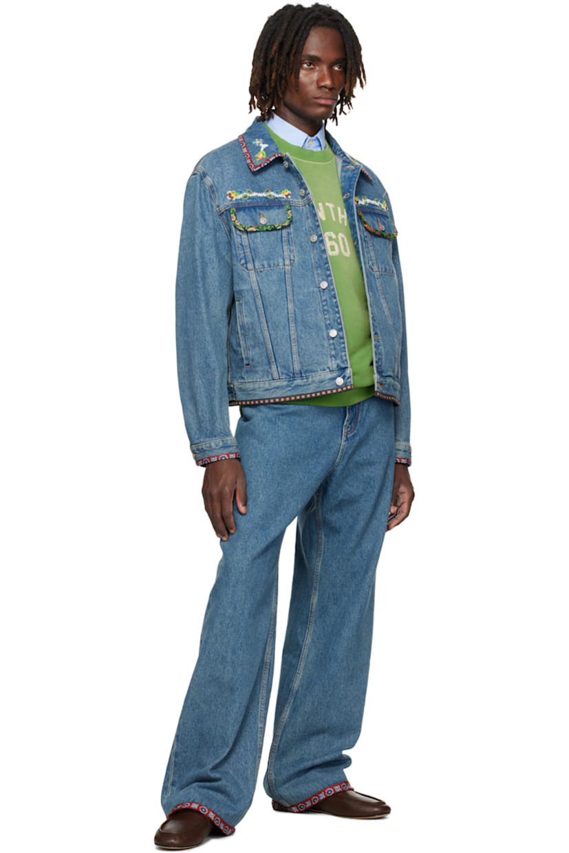 Non-stretch denim jacket.

· Fading and graphic-printed poplin trim throughout
· Beaded appliqués at spread collar and chest
· Button closure
· Flap and welt pockets at front
· Buttoned cuffs
· Logo patch and adjustable button tabs at back hem
· Contrast stitching in tan

Supplier color: Blue