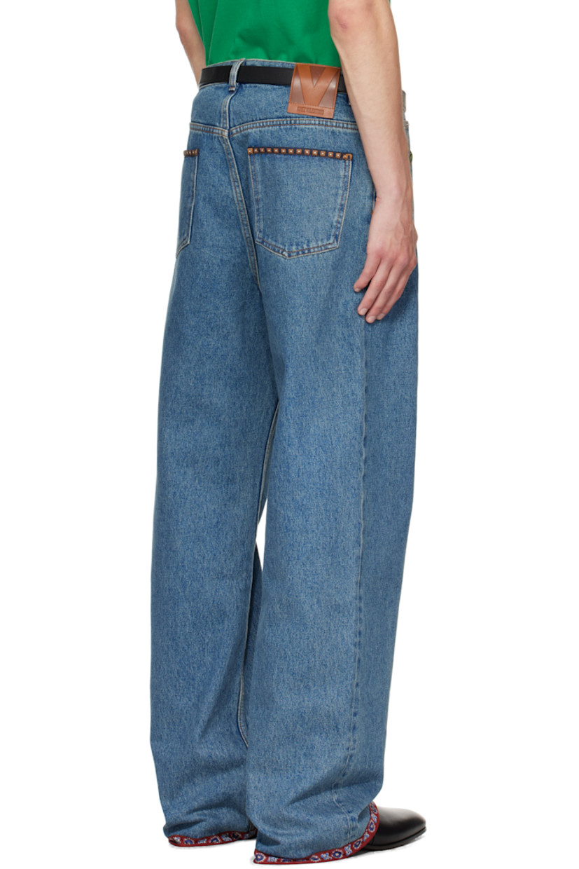 Non-stretch denim jeans. 

· Fading and floral-printed poplin trim throughout
· Loose-fit 
· Belt loops
· Five-pocket styling
· Zip fly 
· Calfskin logo patch at back waistband
· Logo-engraved silver-tone hardware
· Contrast stitching in tan 

Supplier color: Medium blue denim