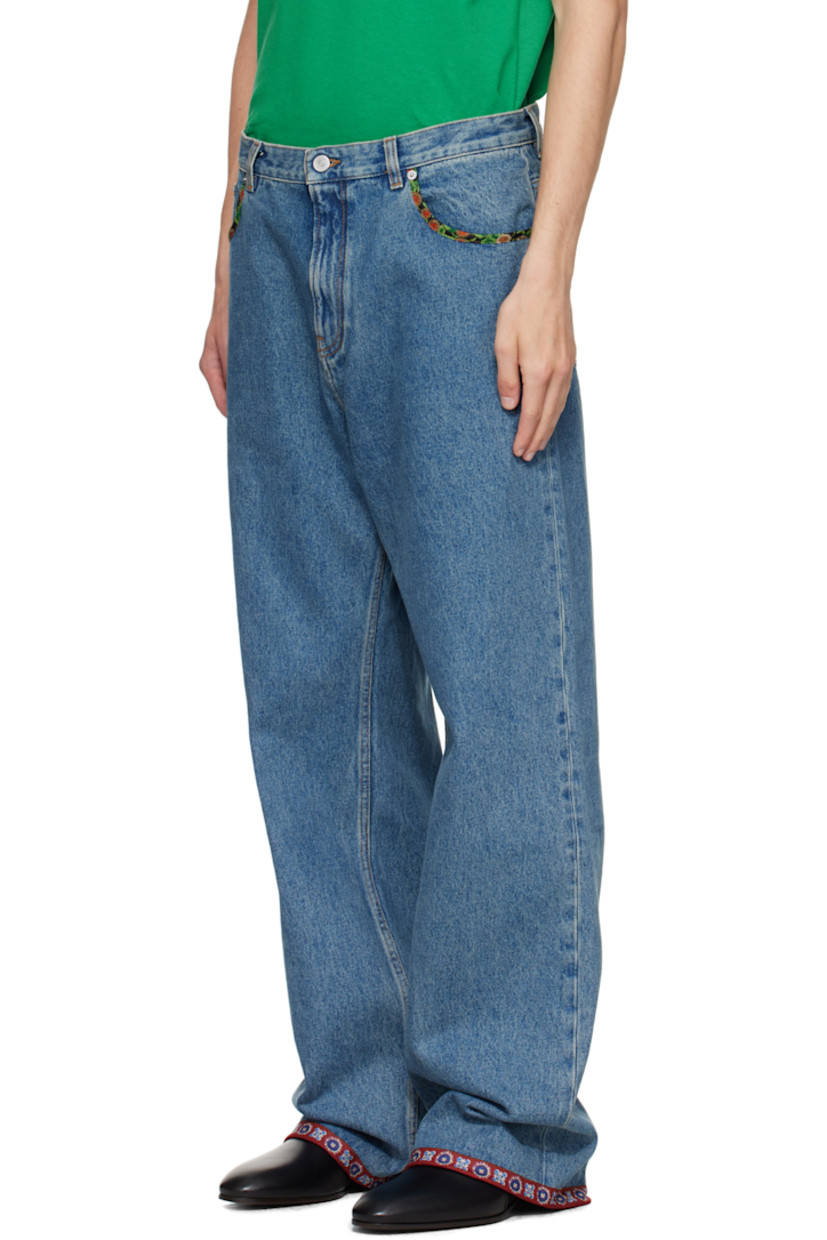 Non-stretch denim jeans. 

· Fading and floral-printed poplin trim throughout
· Loose-fit 
· Belt loops
· Five-pocket styling
· Zip fly 
· Calfskin logo patch at back waistband
· Logo-engraved silver-tone hardware
· Contrast stitching in tan 

Supplier color: Medium blue denim