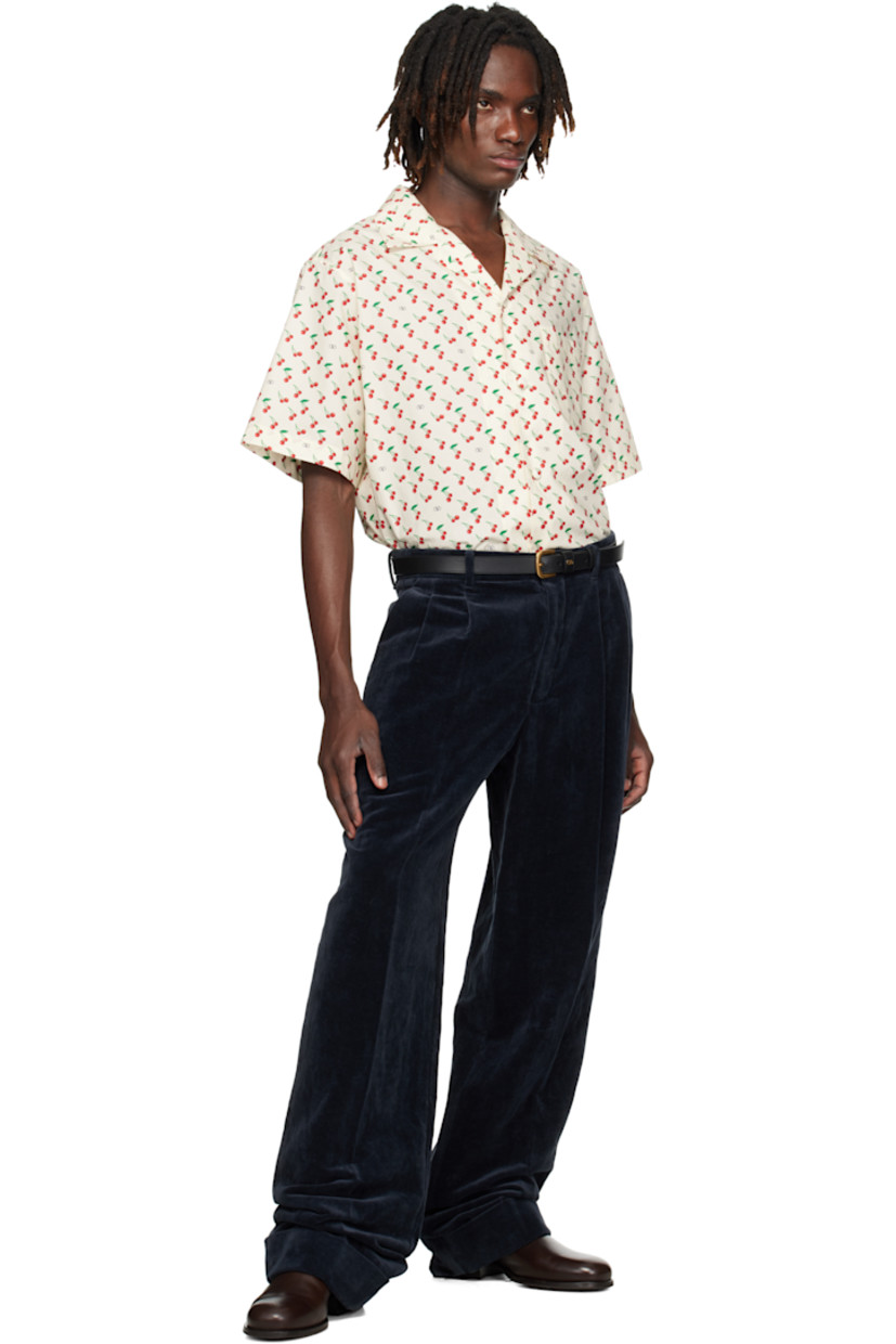 Cotton poplin shirt.

· Logo and graphic pattern printed throughout
· Open spread collar
· Button closure
· Patch pocket at chest

Supplier color: Butter