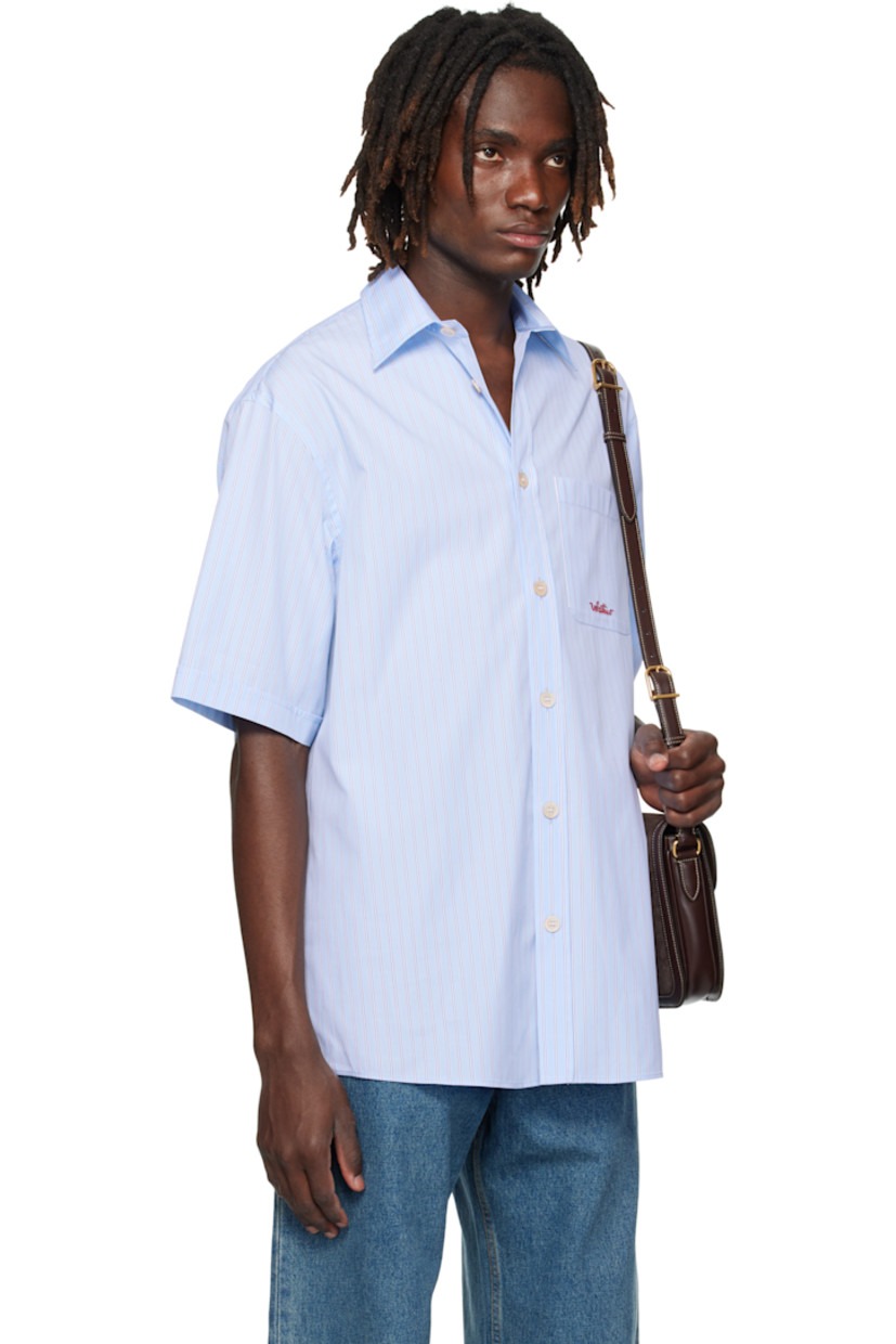Cotton poplin shirt.

· Stripes throughout
· Spread collar
· Button closure
· Logo-embroidered patch pocket at chest
· Shirttail hem
· Pleats at back yoke

Supplier color: Sky blue
