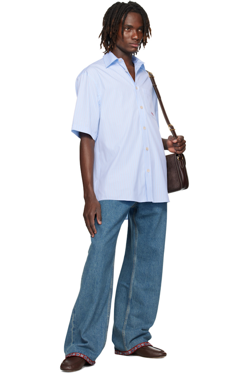 Cotton poplin shirt.

· Stripes throughout
· Spread collar
· Button closure
· Logo-embroidered patch pocket at chest
· Shirttail hem
· Pleats at back yoke

Supplier color: Sky blue
