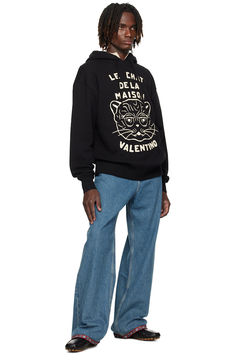 French terry hoodie.

· Drawstring at hood
· Text, graphic, and logo printed at front
· Kangaroo pocket at waist
· Rib-knit hem and cuffs
· Dropped shoulders

Supplier color: Black/Butter