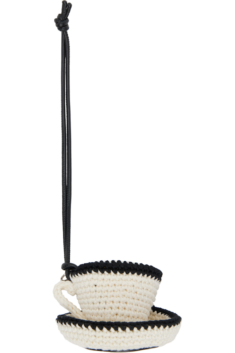Grained calfskin keychain.

· Crocheted cotton graphic charm with logo disc 
· Logo-embossed calfskin trim at base 
· H9.5" x W3" x D2"

Supplier color: Off-white