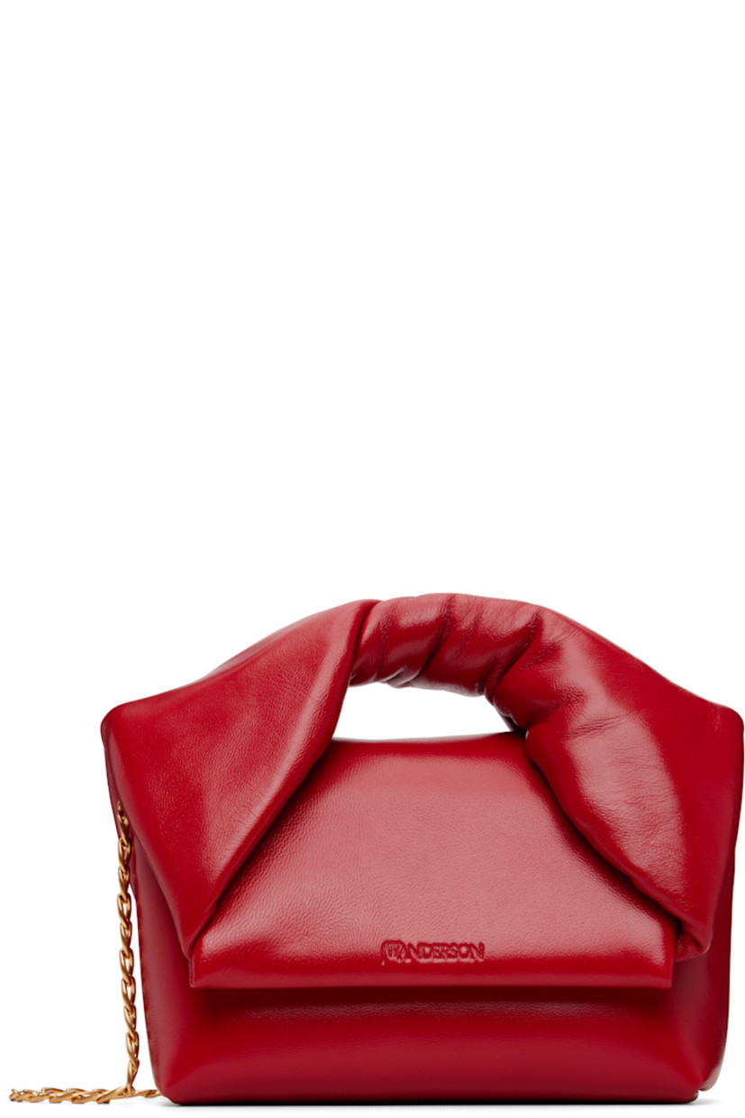 Crinkled patent lambskin top handle bag.

· Twisted detailing at carry handle
· Detachable curb chain crossbody strap
· Logo embossed at magnetic flap closure 
· Card slot at interior 
· H4" x W7.5" x D2.5" 
· Total height: H6.5"

Supplier color: Crimson red