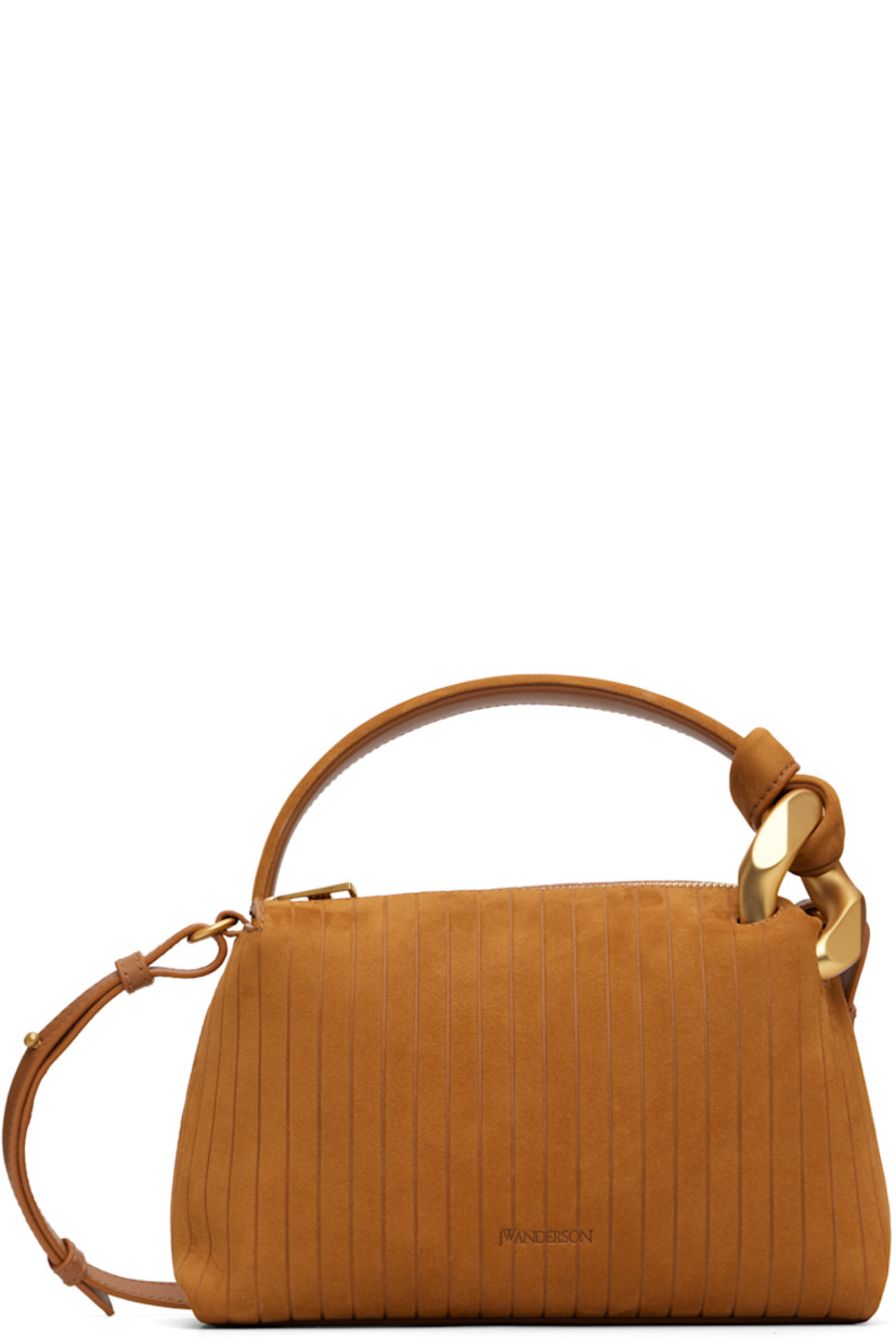 Calfskin suede shoulder bag. 

· Stripes embossed throughout 
· Curb chain hardware at carry handle
· Adjustable and detachable crossbody strap
· Logo embossed at face
· Zip closure
· Faille lining
· H6" x W9" x D4"

Supplier color: Caramel