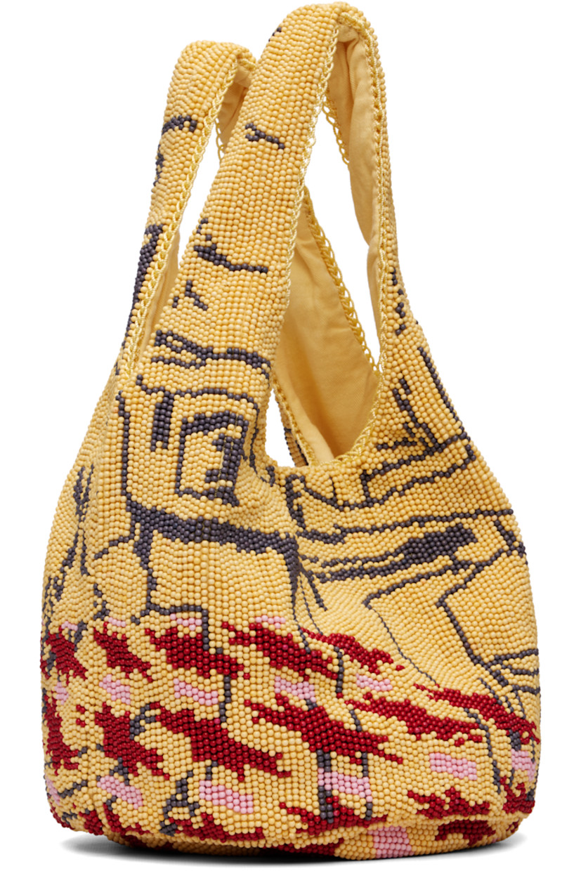 Beaded tote. 

· Graphic pattern throughout
· Integrated carry handles
· Magnetic press-stud closure 
· Cotton twill lining
· H7" x W12" x D8"

Supplier color: Multi