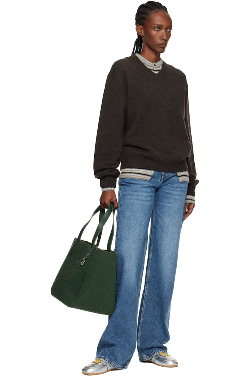 Melton tote.

· Fixed shoulder straps
· Pin-buckle hardware and embroidered logo at face
· Bumper pads at base
· Self-tie closure
· Patch pocket at interior
· H12" x W18" x D9"

Supplier color: Pine
