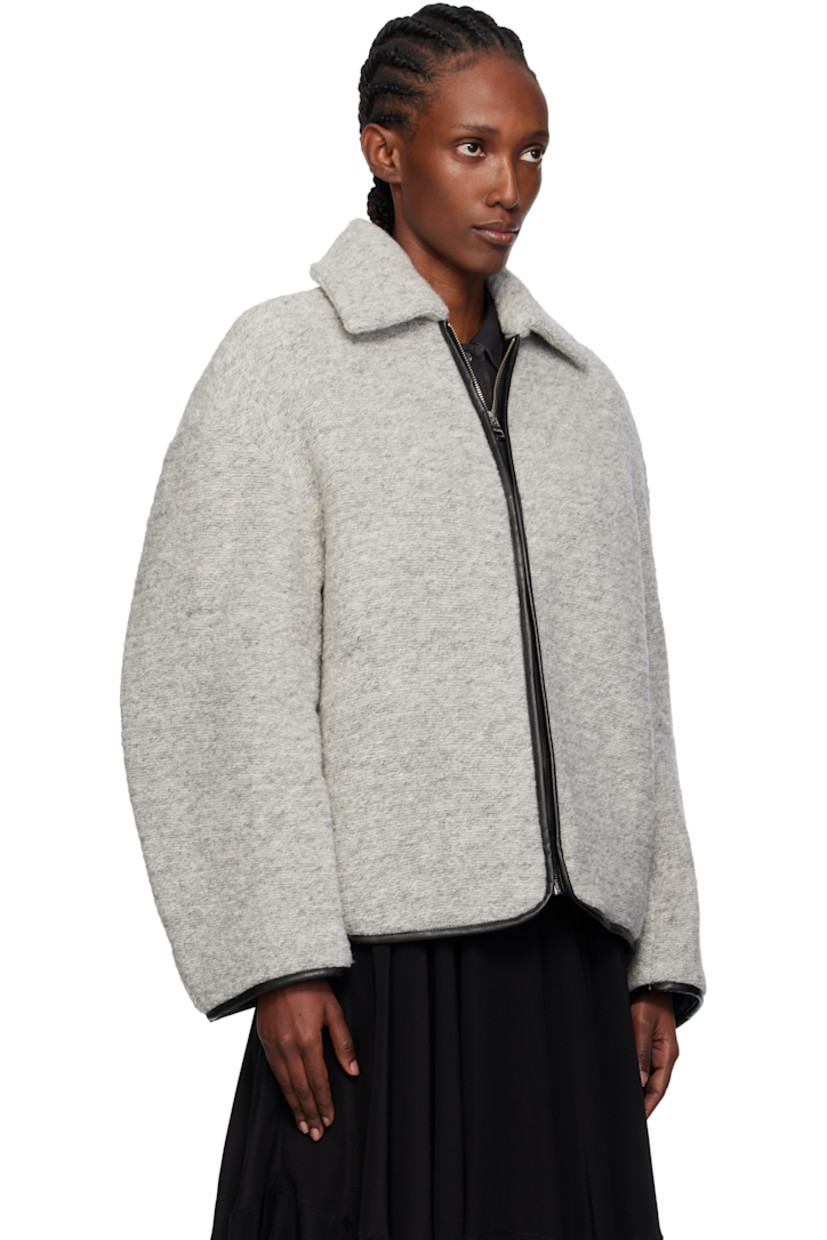 Insulated knit wool-blend jacket. 

· Grained leather trim throughout
· Spread collar
· Zip closure
· Seam pockets at waist 
· Logo patch at back
· Full quilted twill lining

Supplier color: Light grey melange