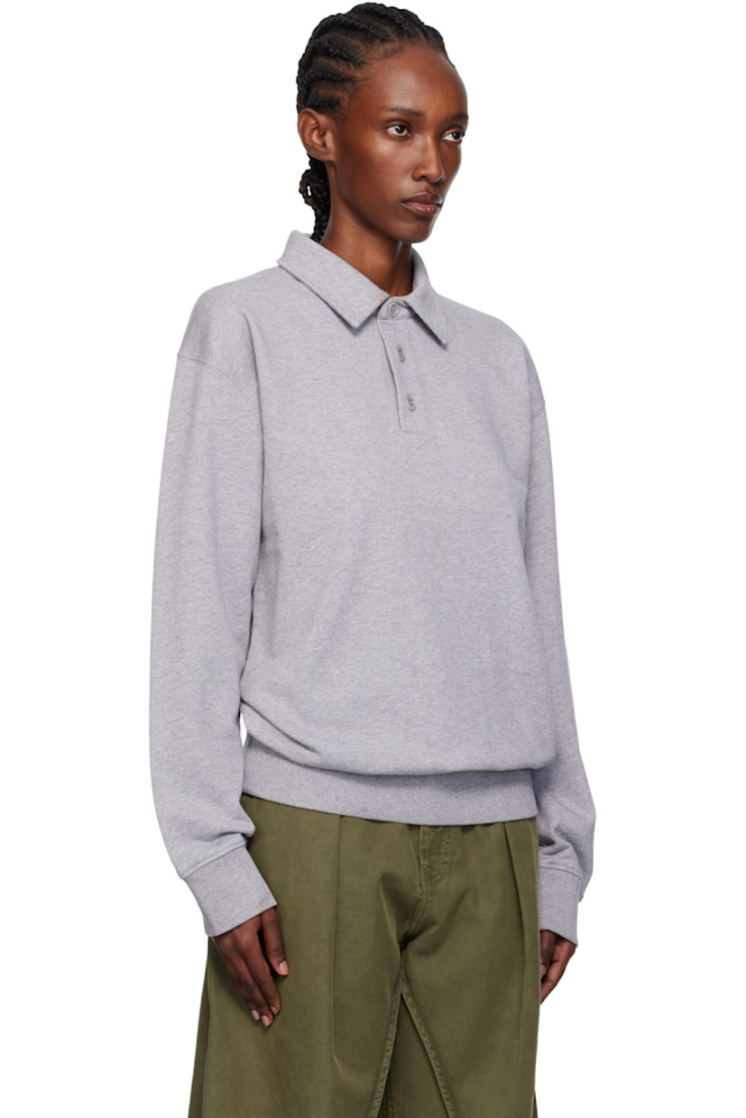 French terry polo.

· Spread collar
· Three-button placket
· Rib-knit hem and cuffs
· Logo embroidered at back collar

Supplier color: Mid grey melange