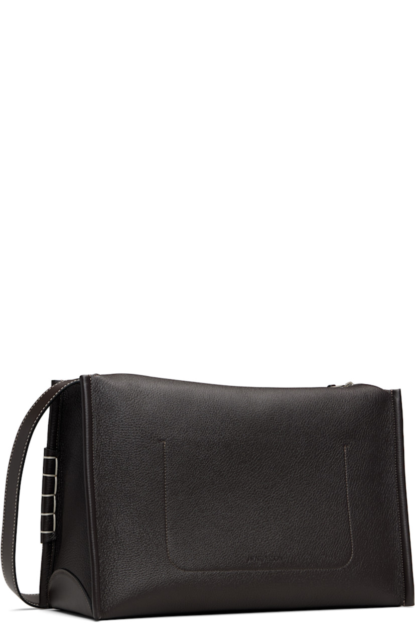 Pebble-grained calfskin shoulder bag. 

· Adjustable and detachable shoulder strap
· Strap with cutout and blanket stitching at face
· Logo embossed at back face
· Zip closure
· Patch pocket at interior 
· Suede lining 
· H11.5" x W16" x D6.5"

Supplier color: Chocolate brown