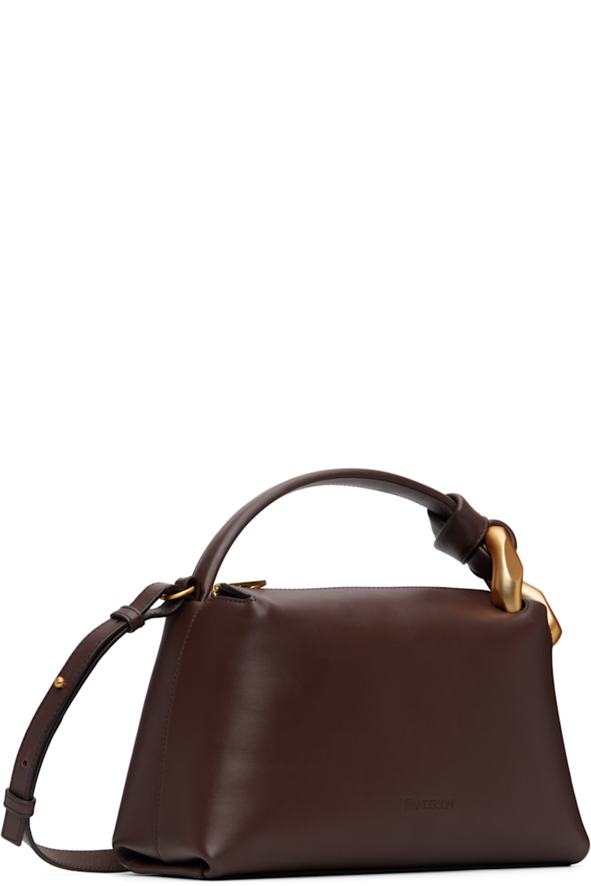 Grained calfskin messenger bag. 

· Curb chain hardware at carry handle
· Adjustable and detachable crossbody strap
· Logo embossed at face
· Zip closure
· Faille lining
· H7" x W11.5" x D4"

Supplier color: Deep walnut
