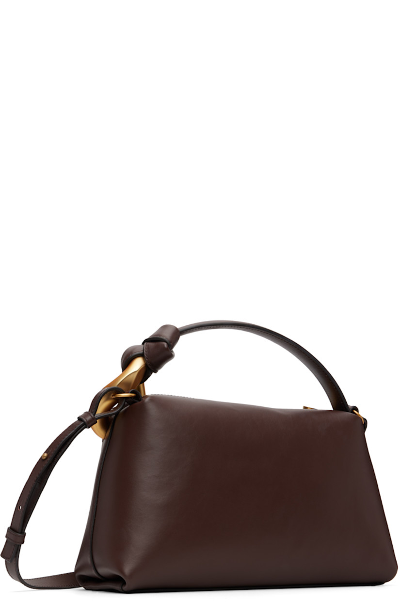 Grained calfskin messenger bag. 

· Curb chain hardware at carry handle
· Adjustable and detachable crossbody strap
· Logo embossed at face
· Zip closure
· Faille lining
· H7" x W11.5" x D4"

Supplier color: Deep walnut