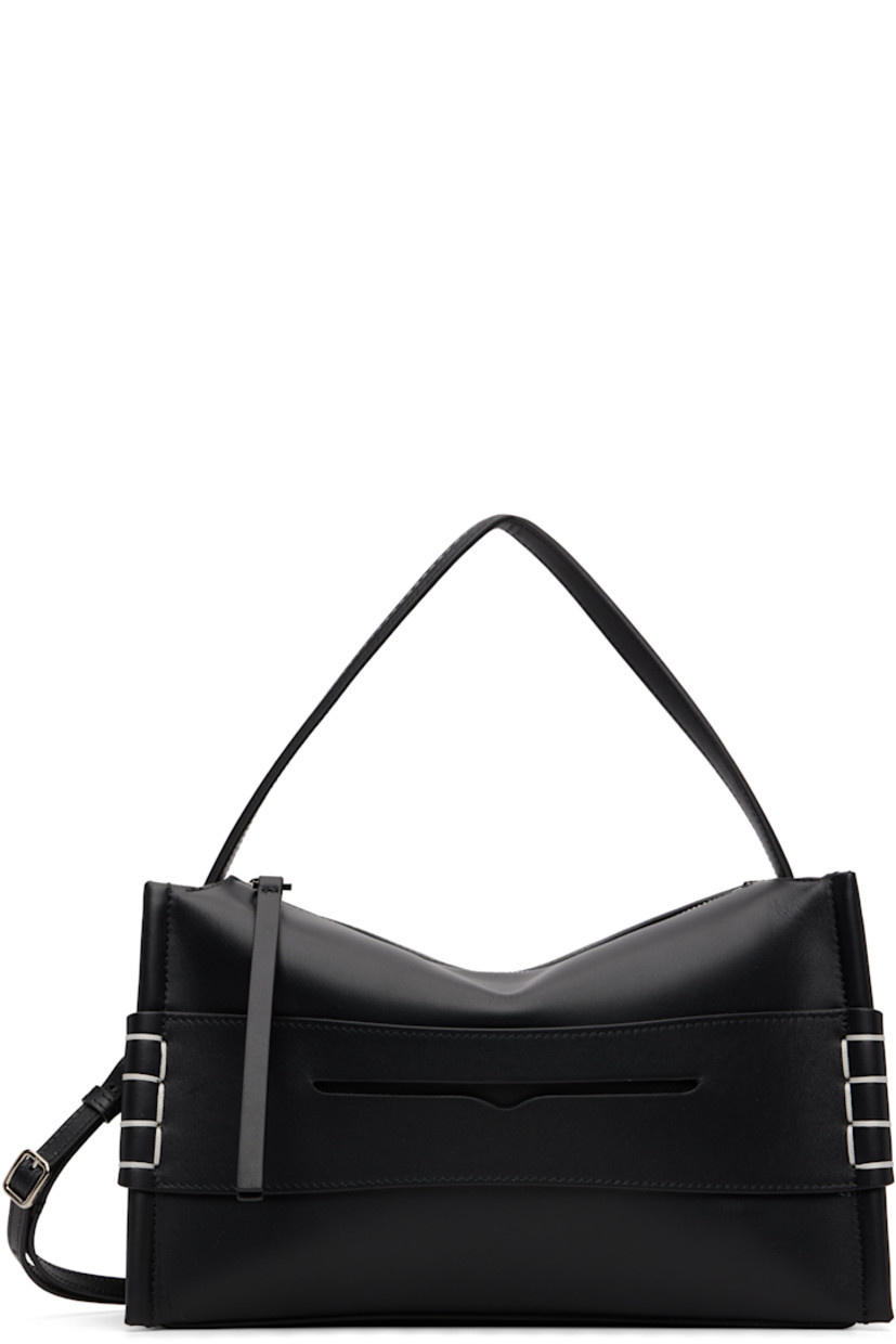 Grained calfskin messenger bag. 

· Fixed carry handle 
· Adjustable and detachable crossbody strap
· Strap with cutout and blanket stitching at face
· Logo embossed at back face
· Zip closure
· Patch pocket at interior 
· Suede lining 
· H7" x W11" x D4"

Supplier color: Black