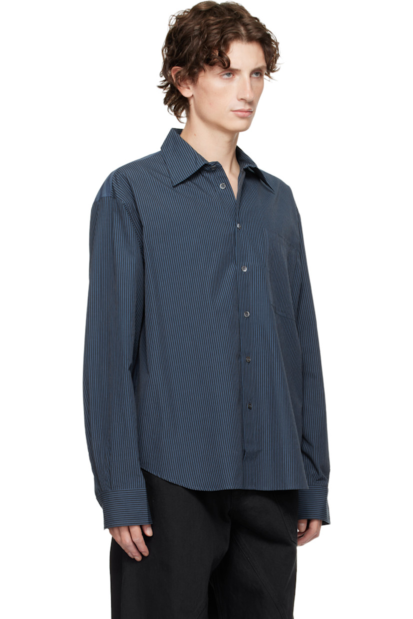 Woven cotton shirt.

· Paneled construction 
· Stripes throughout 
· Spread collar 
· Button closure 
· Patch pocket at chest
· Shirttail hem 
· Pleats at buttoned barrel cuffs
· Logo embroidered at cuff
· Box pleat at back yoke 

Supplier color: Navy