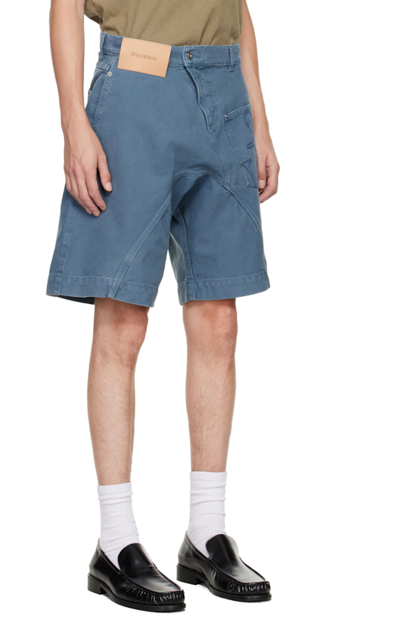 Non-stretch denim shorts.

· Asymmetrical construction 
· Fading and whiskering throughout
· Belt loops
· Four-pocket styling
· Zip fly
· Logo patch at front waistband
· Logo embroidered at front 

Supplier color: Steel blue