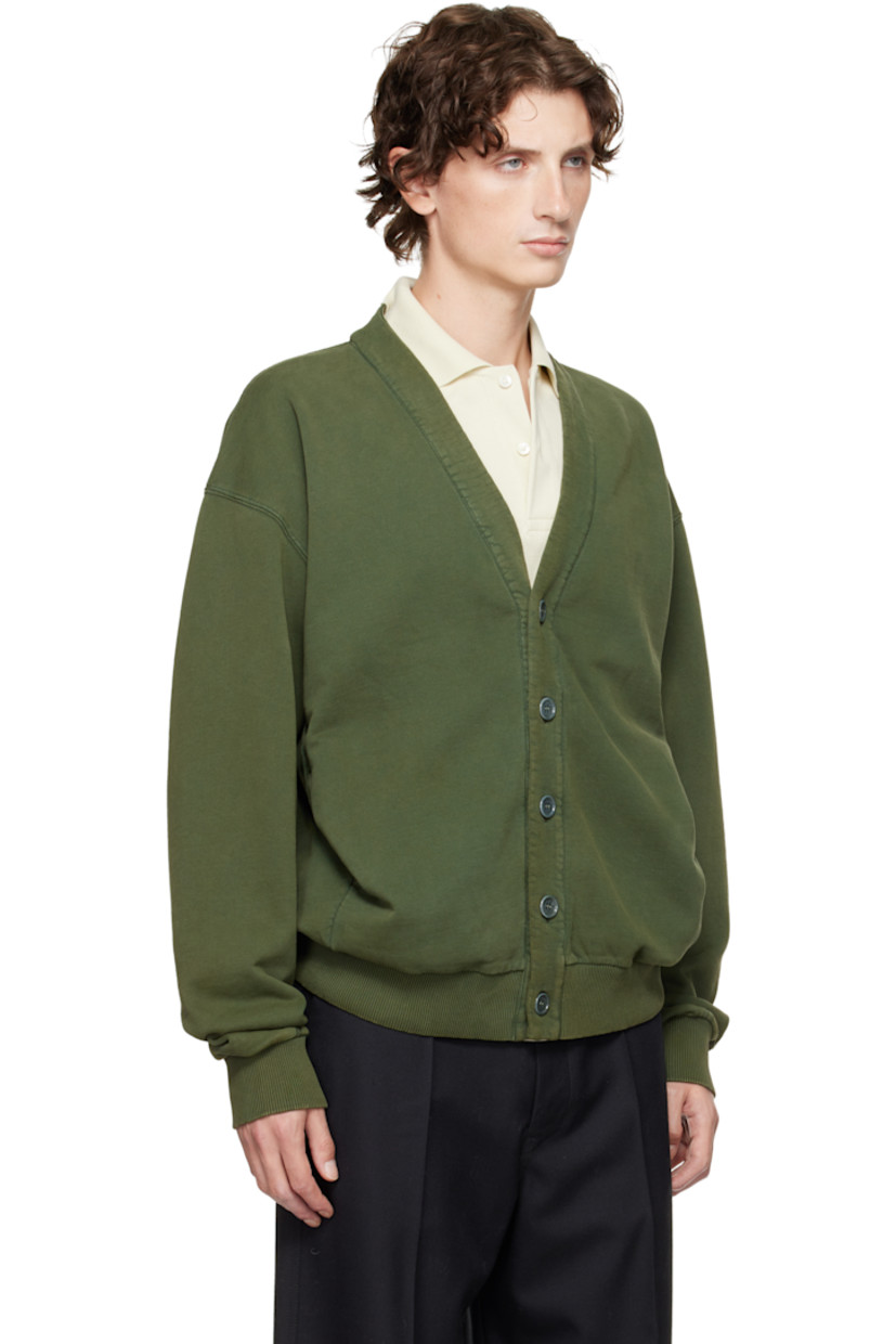 French terry cardigan. 

· Garment-dyed
· Y-neck 
· Button closure
· Seam pockets at waist 
· Rib-knit hem and cuffs
· Dropped shoulders
· Logo embroidered at back hem

Supplier color: Pine