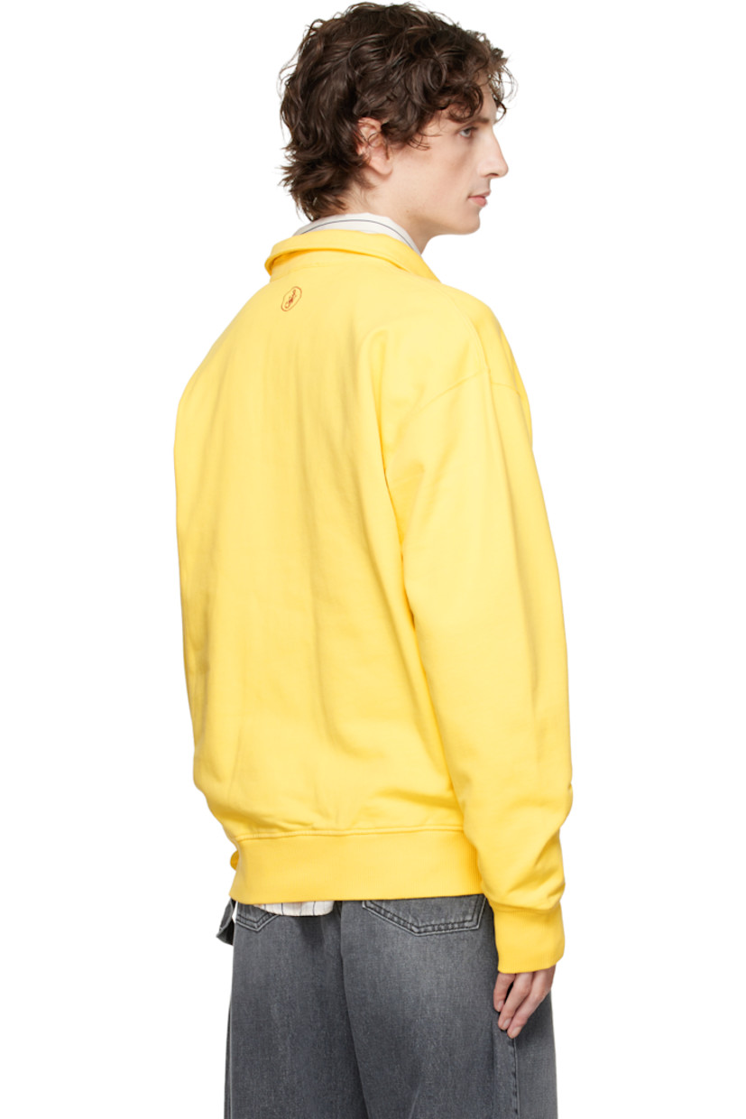 French terry polo. 

· Spread collar 
· Three-button placket 
· Rib-knit hem and cuffs
· Dropped shoulders
· Logo embroidered at back collar 

Supplier color: Lemon
