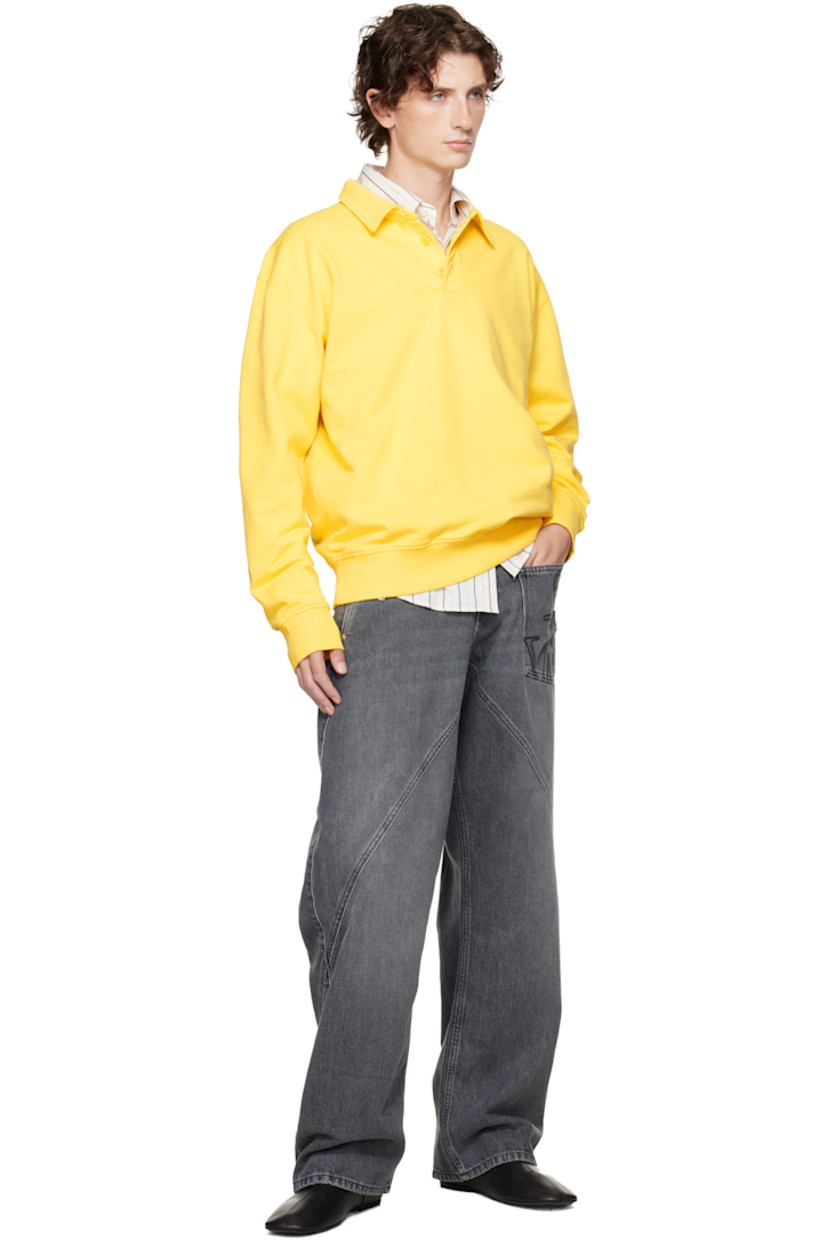 French terry polo. 

· Spread collar 
· Three-button placket 
· Rib-knit hem and cuffs
· Dropped shoulders
· Logo embroidered at back collar 

Supplier color: Lemon