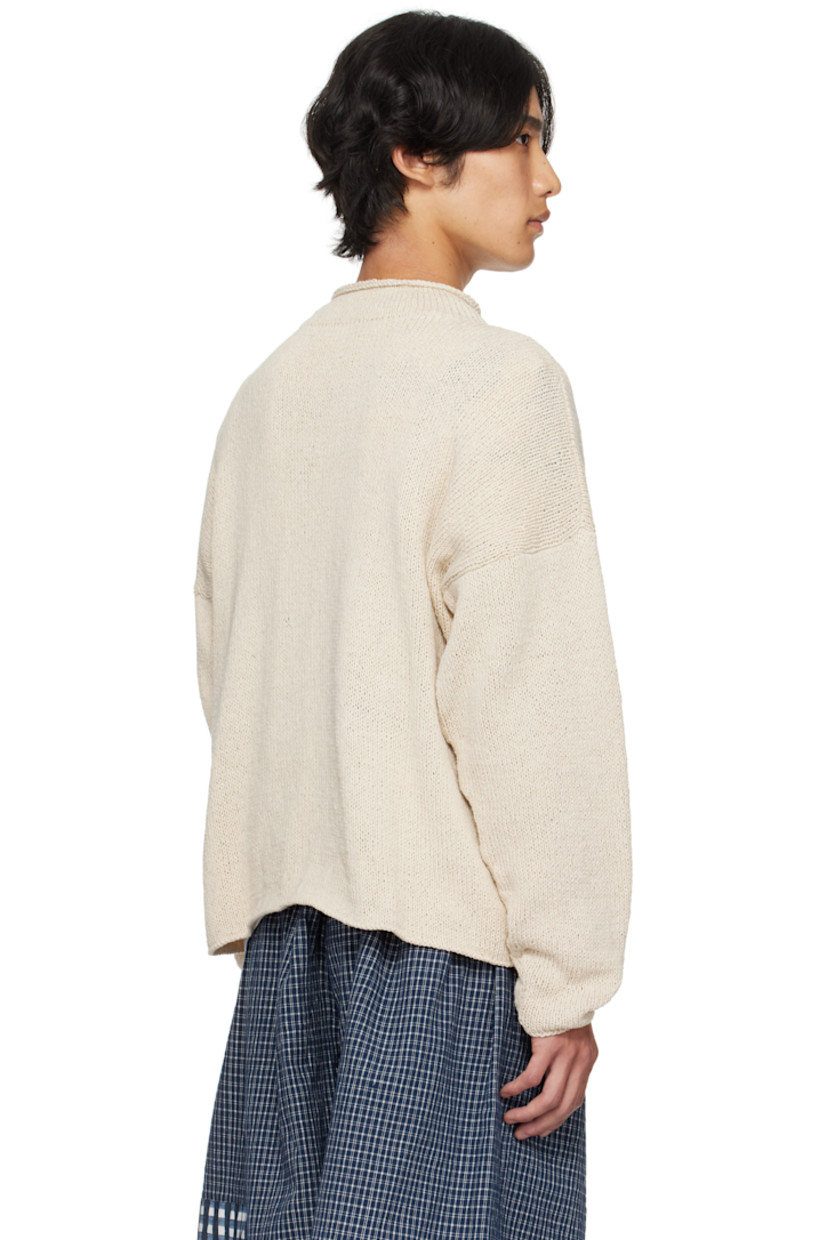 Hand-knit organic cotton sweater. Dyed with natural indigo, pomegranate, kaduka, karuvelam pattai bark, and sevilokodi flower.

· Rolled edge at crewneck
· Hand crocheted floral text at front
· Dropped shoulders

Supplier color: Ecru Tree Hugger