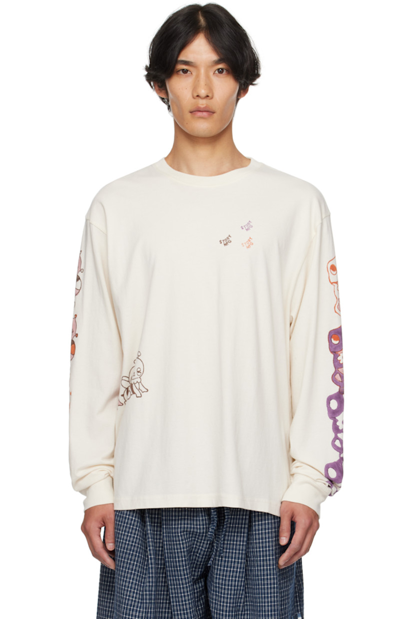 Organic cotton jersey T-shirt.

· Hand-applied block-printed graphics throughout
· Rib-knit crewneck and cuffs

Features artwork by Shana Sadeghi-Ray. Printed by Tharangini Studio.

Supplier color: Ecru Earth Trip