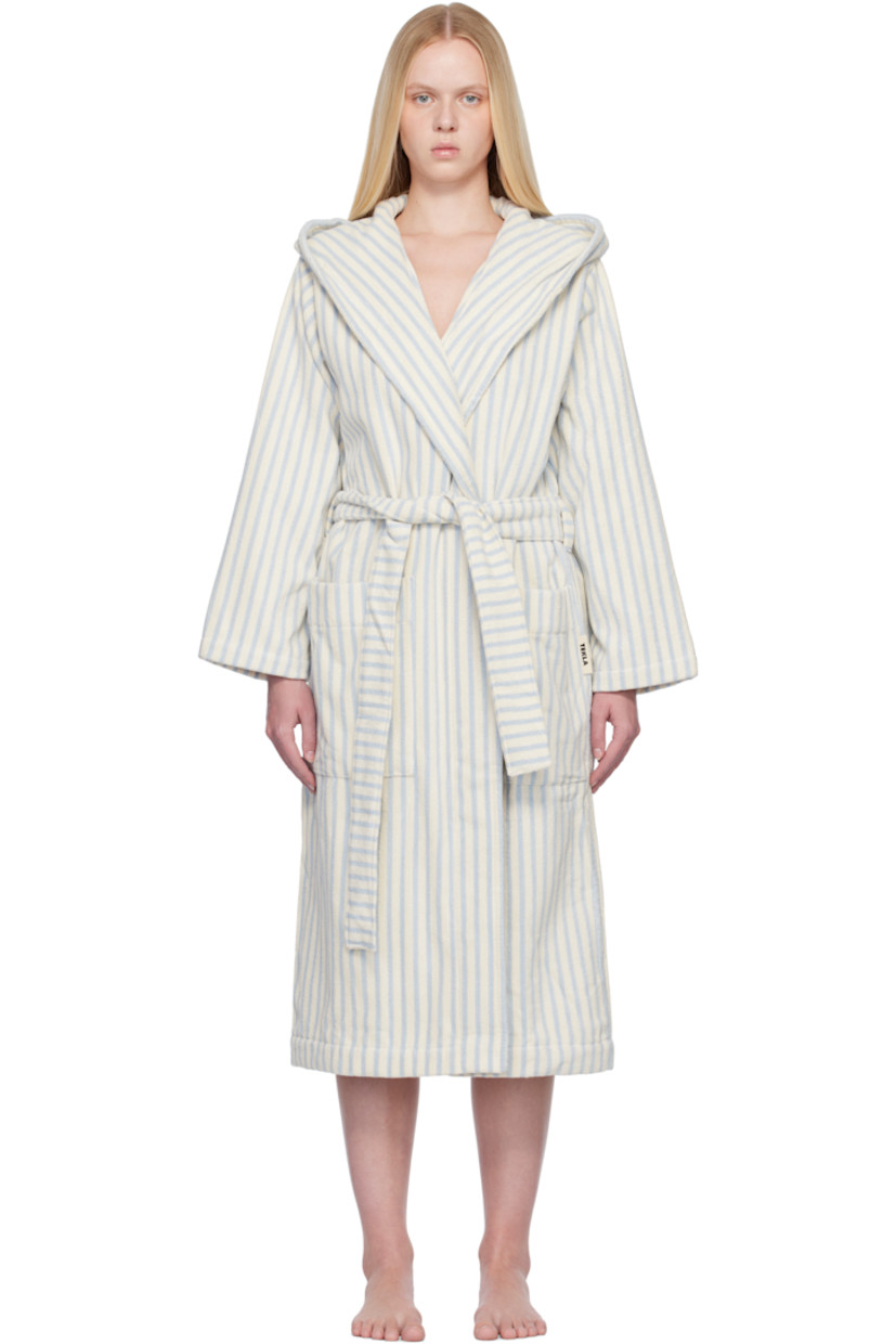 Heavyweight 385 gsm organic cotton terrycloth bathrobe. Stripes throughout.

· Certified GOTS and OEKO-TEX® Standard 100
· Hood at shawl lapel
· Open front
· Belt loops and detachable self-tie belt
· Patch pockets
· Logo flag at side seam
· Locker loop at inner collar

Supplier color: Soft blue stripes