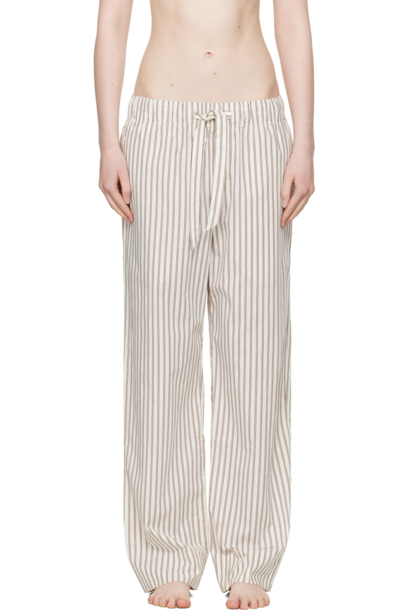Lightweight organic cotton poplin pyjama pants. Stripes throughout. 

· Certified OEKO-TEX® Standard 100
· Straight-leg and loose-fit 
· Stonewashed
· Drawstring at elasticized waistband
· Three-pocket styling
· Button fly
· Logo patch at back pocket
· French seams at interior
· Mother-of-pearl hardware

Supplier color: Hopper stripes