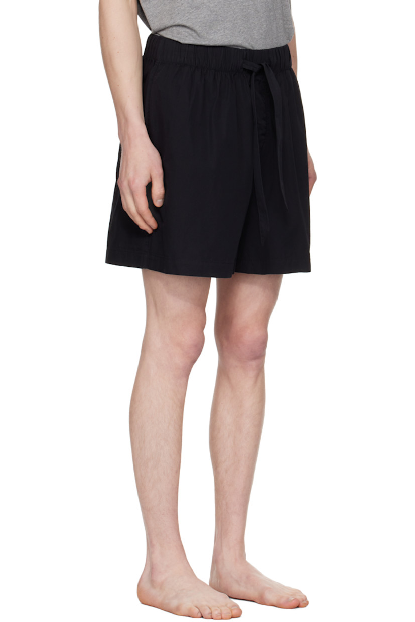Lightweight organic cotton poplin pyjama shorts.

· Certified OEKO-TEX® Standard 100
· Wide-leg 
· Stonewashed
· Drawstring at elasticized waistband
· Four-pocket styling
· Button fly
· Logo patch at back pocket
· French seams at interior
· Mother-of-pearl hardware

Supplier color: All black