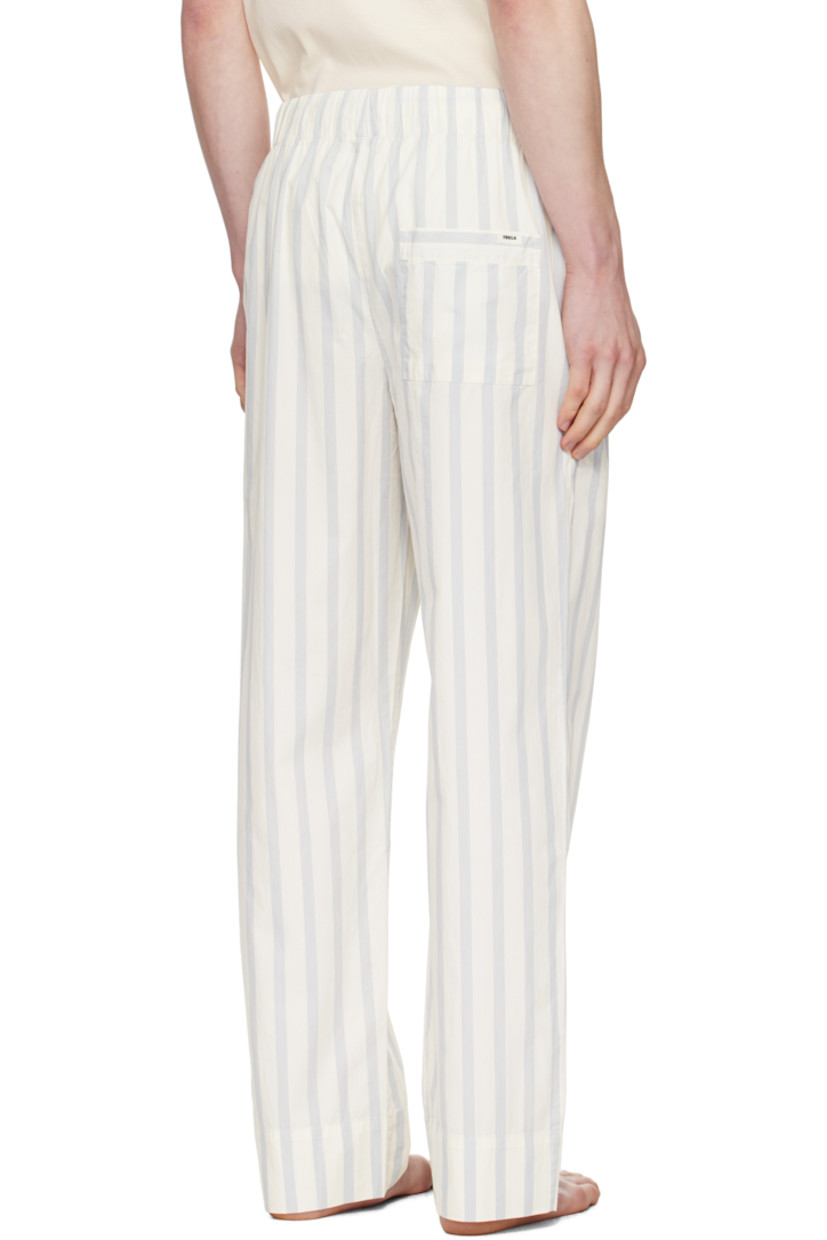 Lightweight organic cotton poplin pyjama pants. Stripes throughout.

· Certified OEKO-TEX® Standard 100
· Straight-leg and loose-fit 
· Stonewashed
· Drawstring at elasticized waistband
· Three-pocket styling
· Button fly
· Logo patch at back pocket
· French seams at interior
· Mother-of-pearl hardware

Supplier color: Needle stripes