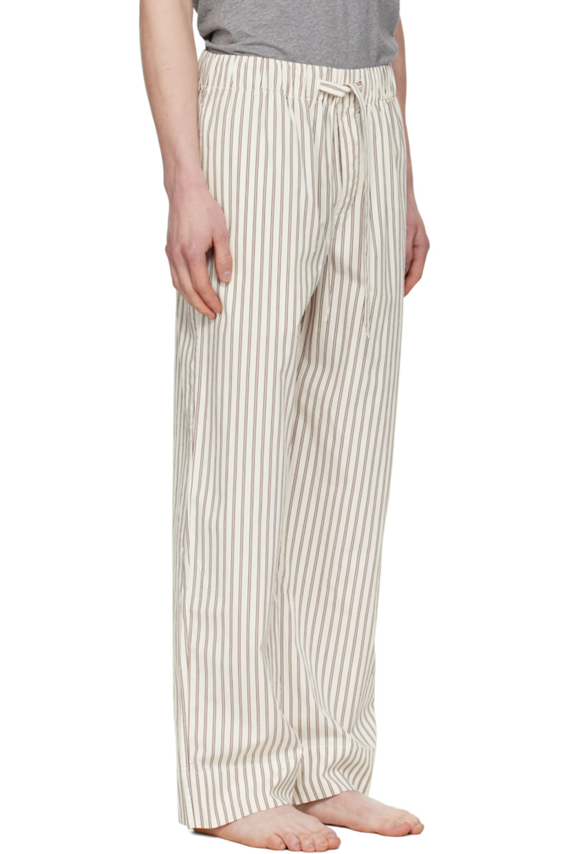 Lightweight organic cotton poplin pyjama pants. Stripes throughout.

· Certified OEKO-TEX® Standard 100
· Straight-leg and loose-fit 
· Stonewashed
· Drawstring at elasticized waistband
· Three-pocket styling
· Button fly
· Logo patch at back pocket
· French seams at interior
· Mother-of-pearl hardware

Supplier color: Hopper stripes