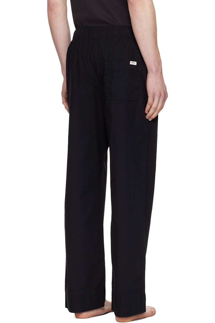 Lightweight organic cotton poplin pyjama pants. 

· Certified OEKO-TEX® Standard 100
· Straight-leg and loose-fit 
· Stonewashed
· Drawstring at elasticized waistband
· Three-pocket styling
· Button fly
· Logo patch at back pocket
· French seams at interior
· Mother-of-pearl hardware

Supplier color: All black