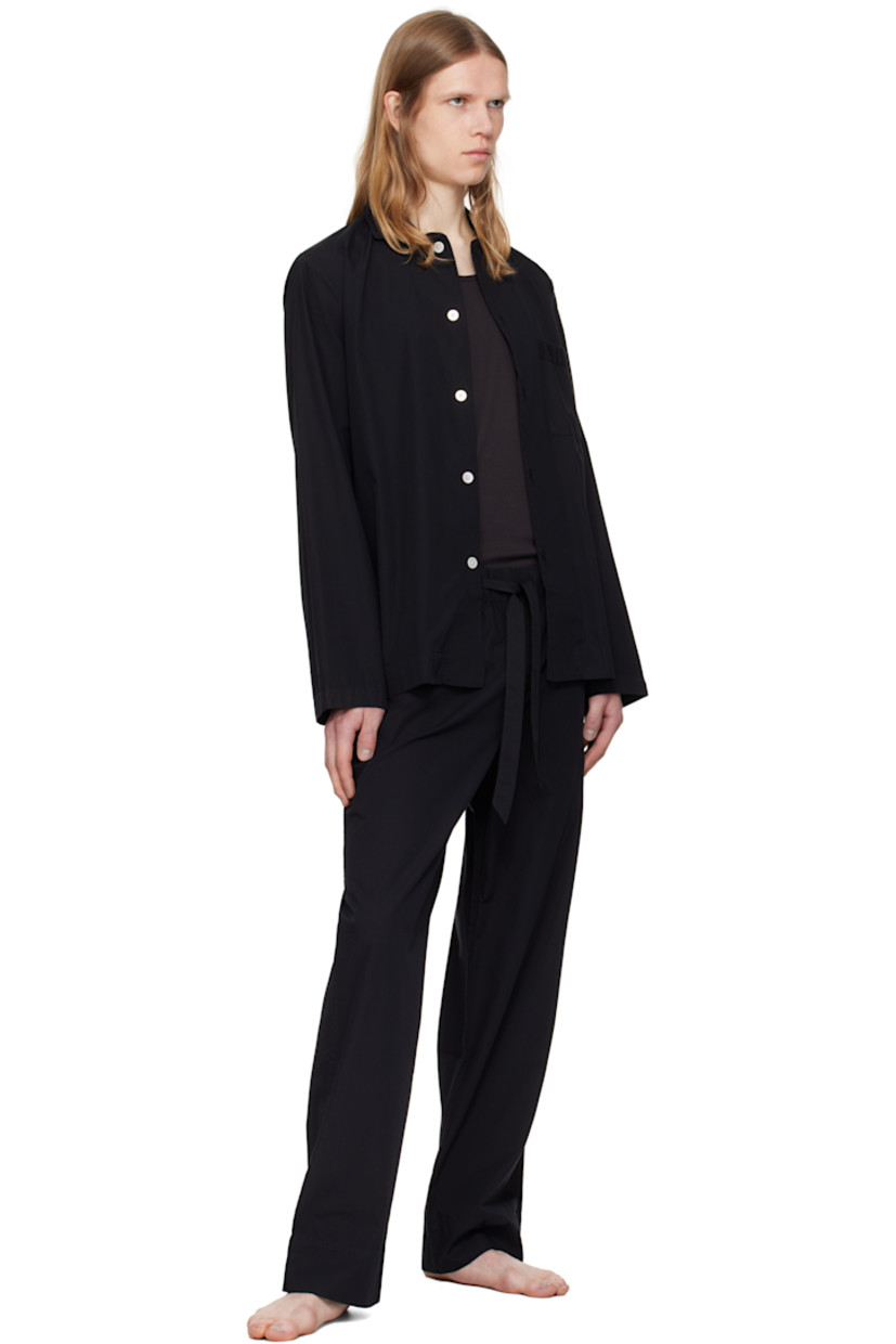 Lightweight organic cotton poplin pyjama pants. 

· Certified OEKO-TEX® Standard 100
· Straight-leg and loose-fit 
· Stonewashed
· Drawstring at elasticized waistband
· Three-pocket styling
· Button fly
· Logo patch at back pocket
· French seams at interior
· Mother-of-pearl hardware

Supplier color: All black