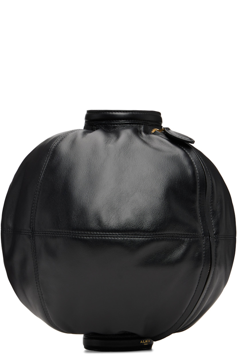 Paneled buffed leather pouch. 

· Sleeve-style construction
· Logo-stamped pin-buckle strap at cuff
· Zip closure 
· Suede lining
· Gold-tone hardware
· H9" x W10.5" x D9"

Supplier color: Black