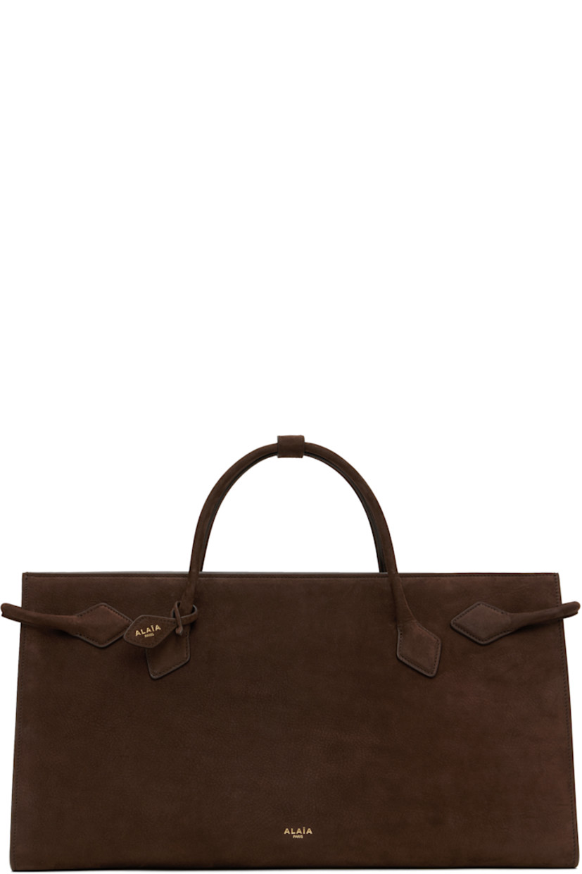 Calfskin nubuck tote in brown.

· Press-stud tab at twin carry handles 
· Detachable logo tag at handle
· Logo stamp at face
· Strap at sides
· Open throat
· Patch pocket at interior 
· Calfskin suede lining 
· Gold-tone hardware
· H9" x W16.5" x D6.5"

Supplier color: Dark brown