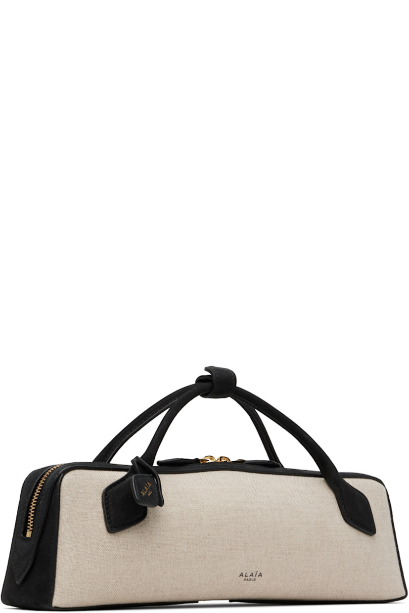 Linen-blend canvas and calfskin suede top handle bag.

· Press-stud tab at fixed rolled carry handles
· Detachable logo tag at handle base
· Logo stamp at face
· Two-way zip closure
· Card slot at interior 
· Suede lining
· Logo-engraved gold-tone hardware 
· H3.5" x W12" x D2.5" 

Supplier color: Noir