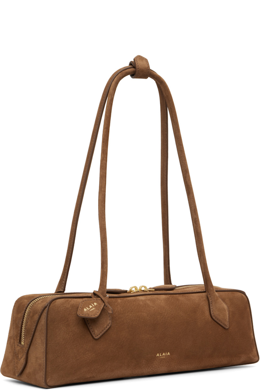 Calfskin nubuck shoulder bag.

· Press-stud tab at rolled shoulder straps
· Detachable logo tag at strap
· Logo stamp at face
· Two-way zip closure
· Card slot with removable mirror at interior
· Calfskin nubuck lining
· Gold-tone hardware
· H3.5" x W13" x D4"

Supplier color: Brown