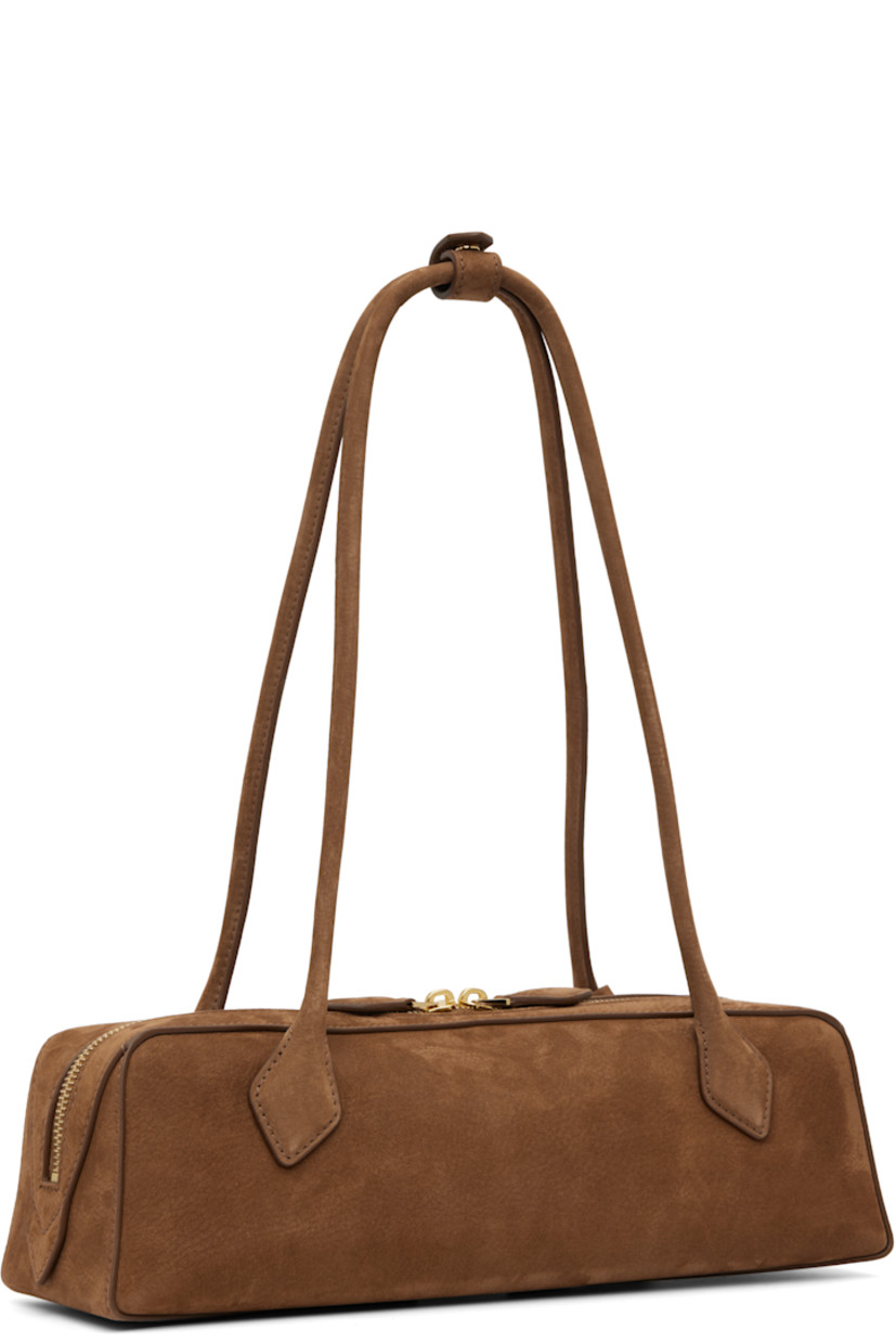 Calfskin nubuck shoulder bag.

· Press-stud tab at rolled shoulder straps
· Detachable logo tag at strap
· Logo stamp at face
· Two-way zip closure
· Card slot with removable mirror at interior
· Calfskin nubuck lining
· Gold-tone hardware
· H3.5" x W13" x D4"

Supplier color: Brown