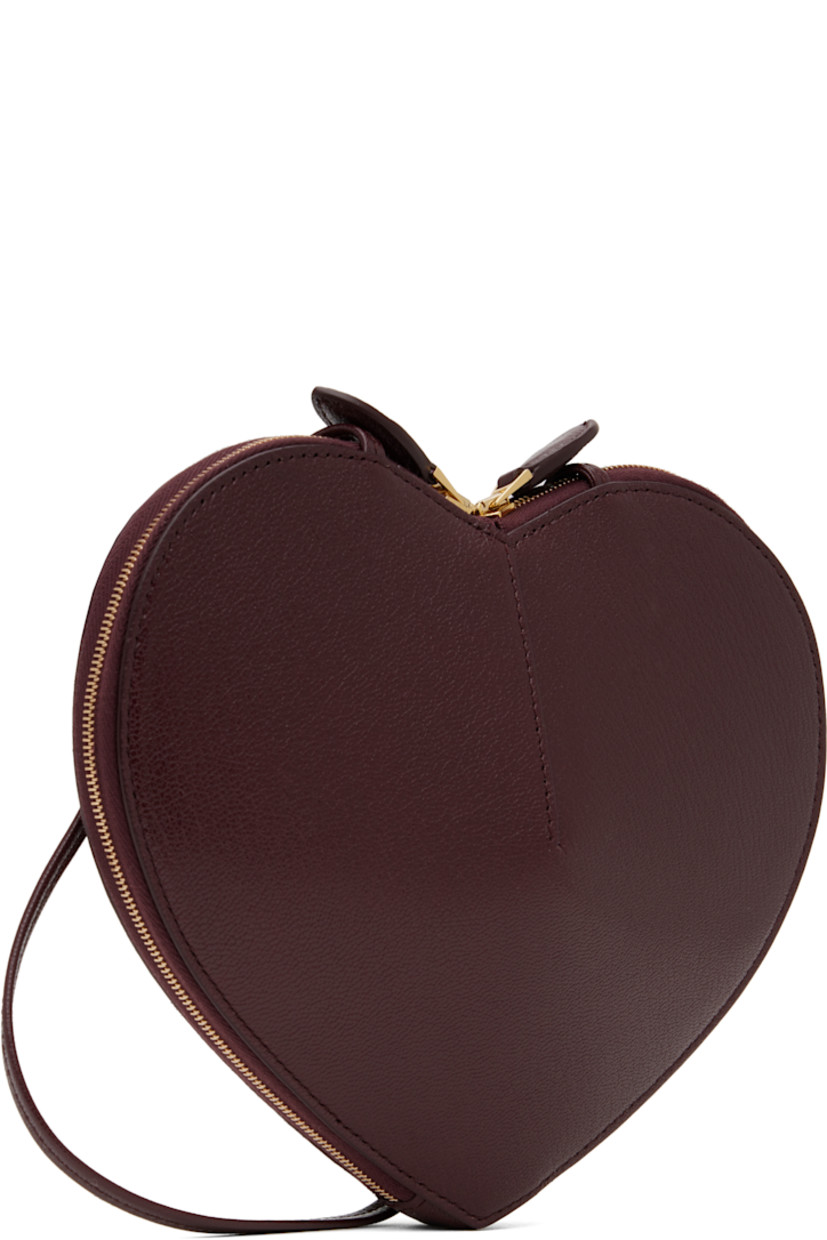 Heart-shaped rigid suede shoulder bag in burgundy. 

· Buffed goatskin trim throughout
· Adjustable crossbody strap
· Logo stamp at face
· Two-way zip closure
· Accordion panels at interior
· Buffed calfskin lining
· Silver-tone hardware
· H7.5" x W8.5" x D3"

Supplier color: Red