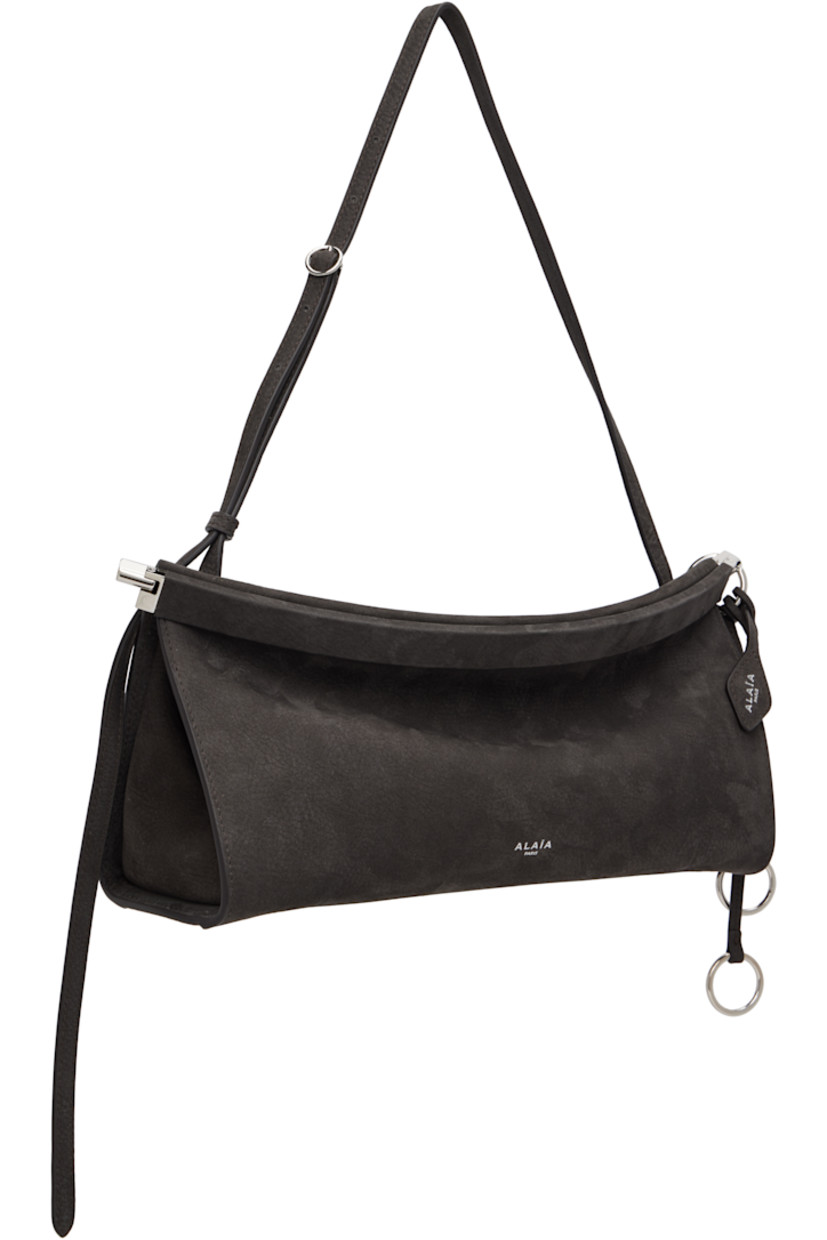 Calfskin nubuck shoulder bag.

· Adjustable shoulder strap
· Silver-tone logo stamp at face
· Detachable logo tag and O-rings at side
· Hinged closure
· Logo-engraved silver-tone hardware
· H5.5" x W12" x D3.5"

Supplier color: Anthracite