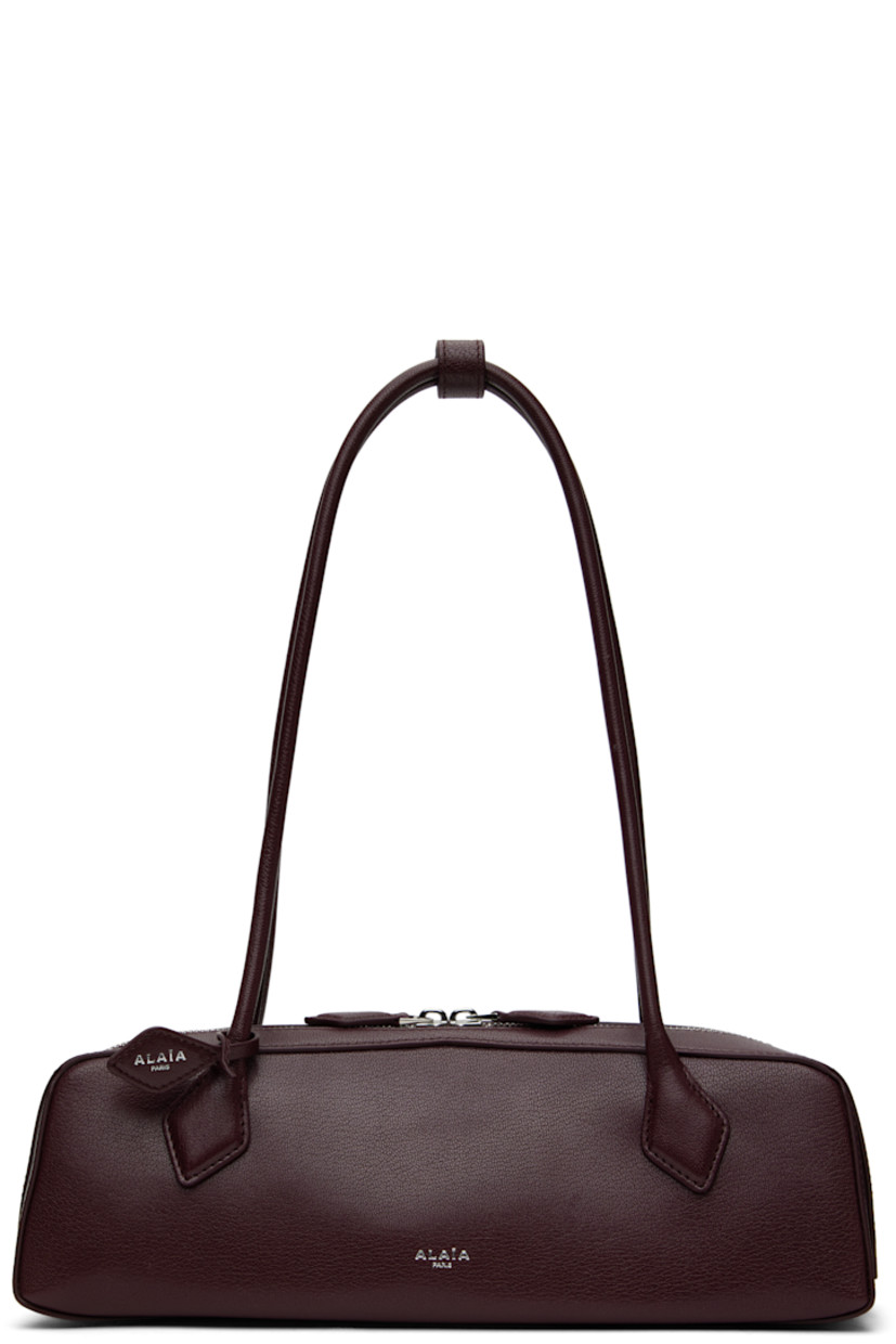 Grained goatskin shoulder bag.

· Press-stud tab at rolled shoulder straps
· Detachable logo tag at strap
· Logo stamp at face
· Two-way zip closure
· Card slot with removable mirror at interior
· Nubuck lining
· Silver-tone hardware
· H3.5" x W13" x D4"

Supplier color: Rouge grenat