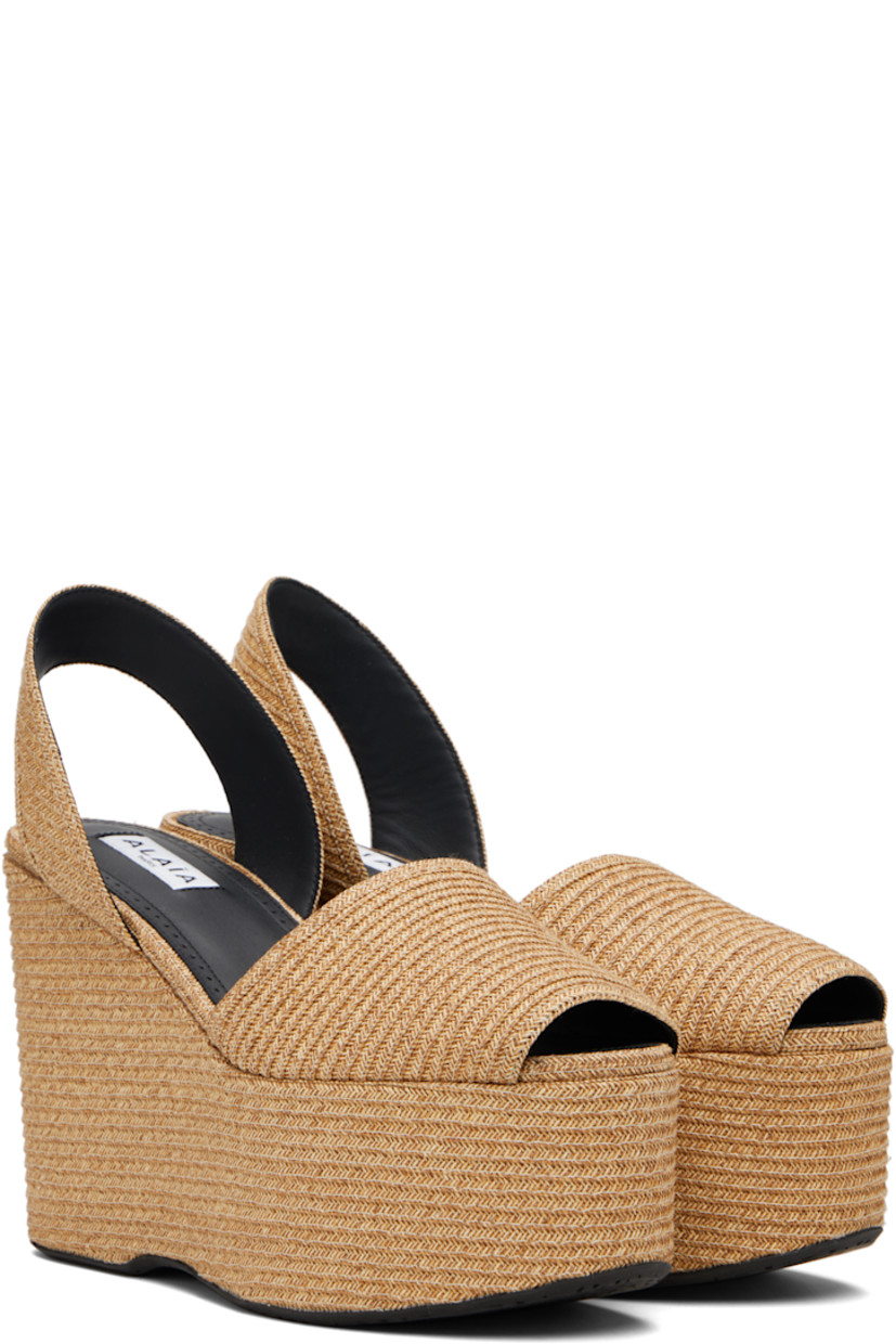Woven paper straw heeled sandals.

· Open toe 
· Slingback strap at heel
· Lambskin lining
· Covered platform midsole and wedge heel
· Rubber sole 
· Platform: H2.5" 
· Heel: H4.5"

Supplier color: Natural