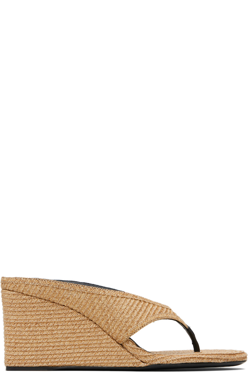 Woven paper straw heeled sandals.

· Open toe 
· Thong-style strap at vamp
· Lambskin lining
· Covered wedge heels with rubber injection
· Calfskin sole 
· Heel: H3"

Supplier color: Natural